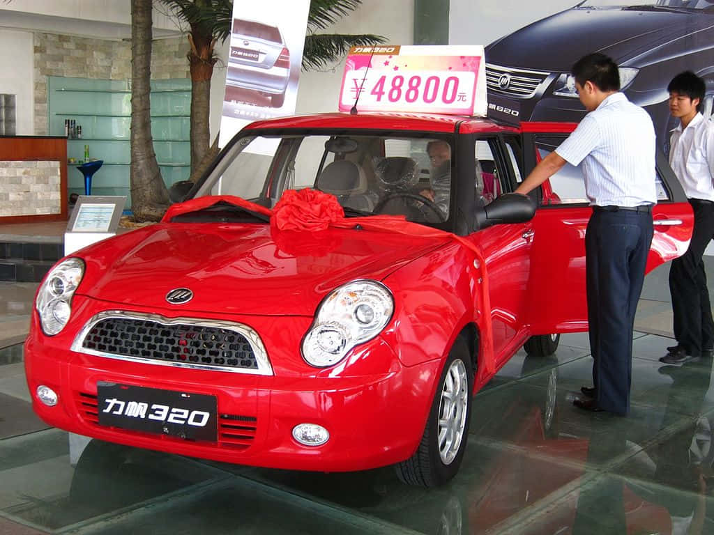 Caption: The Stylish Compact Lifan 320 Car Showcased In The Urban Settings. Wallpaper
