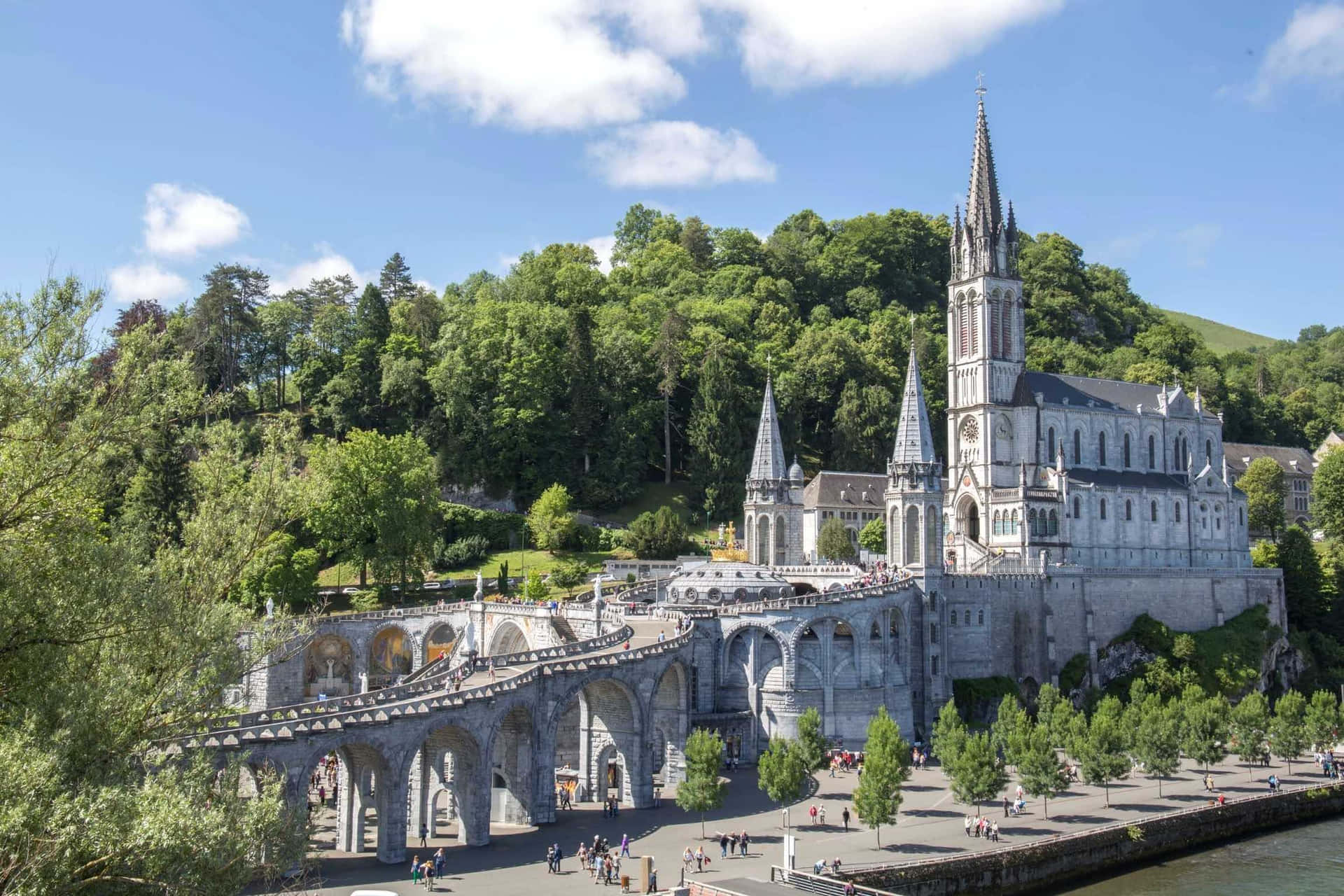 Caption: Tranquil Evening At The Lourdes Sanctuary, France Wallpaper