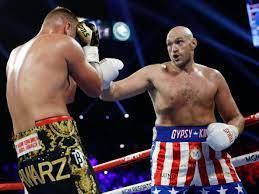 Caption: Tyson Fury Celebrates Victory In Boxing Ring Wallpaper