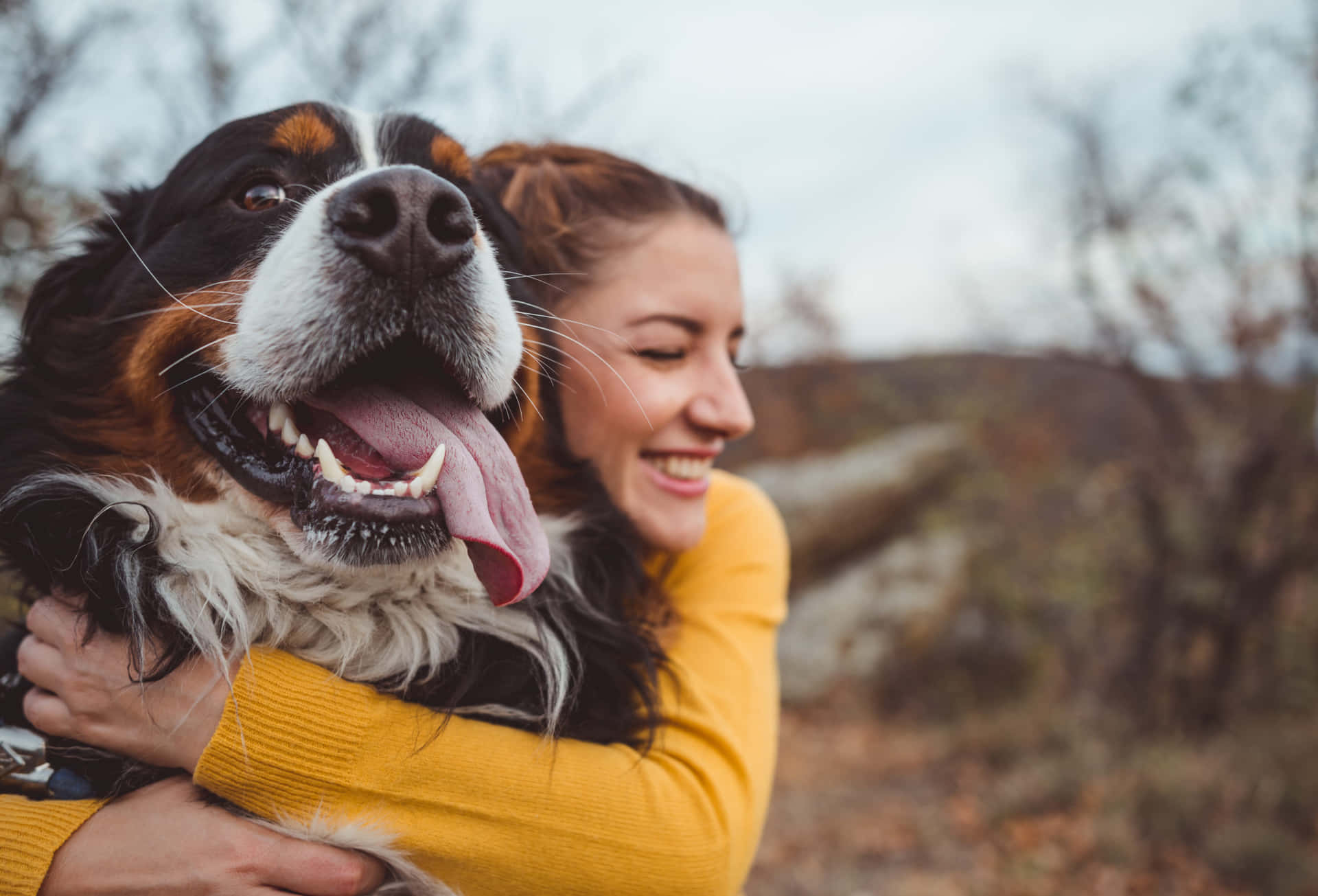 Caption: Unconditional Bond - Man Hugging His Dog Wallpaper