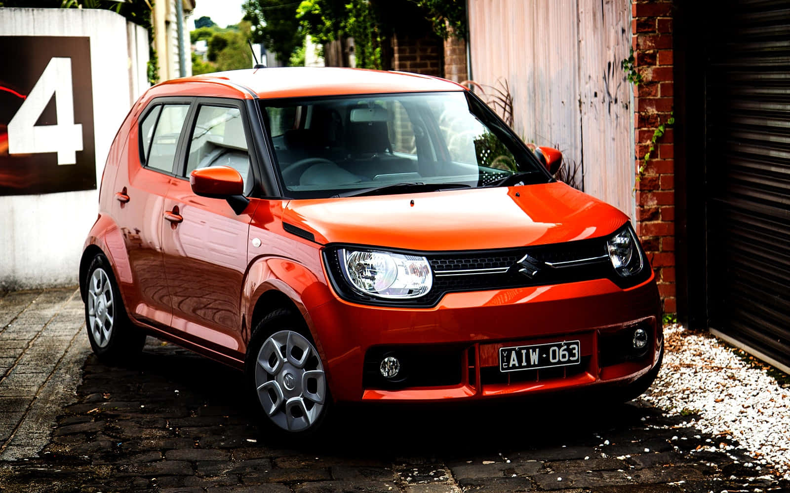 Caption: Vibrant Suzuki Ignis In Urban Landscape Wallpaper