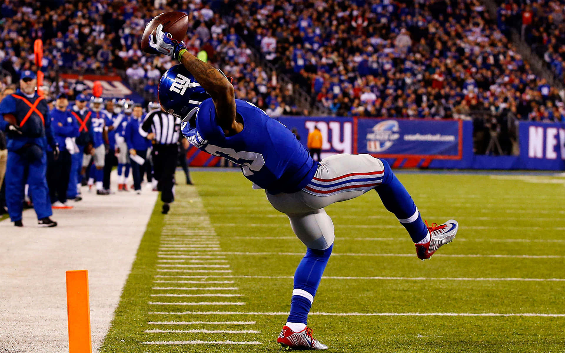 Caption: Wide Receiver Making An Athletic Catch During A Football Match Wallpaper