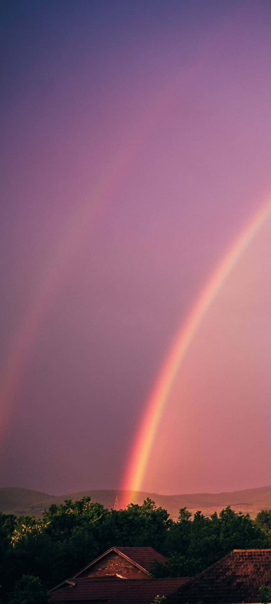Captivating Spectrum Of Rainbow Against A Tranquil Sky