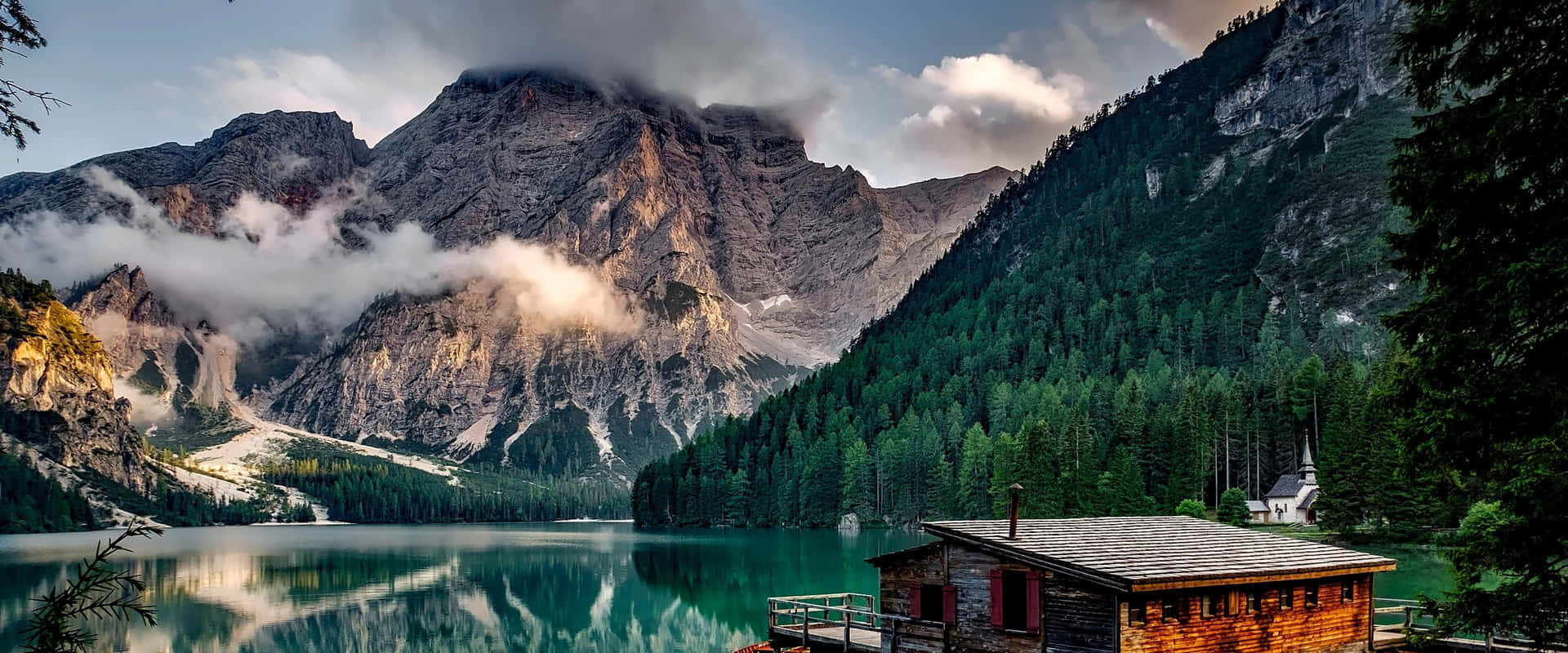 Captivating Tranquility: Azure Lake Against A Mountainous Backdrop