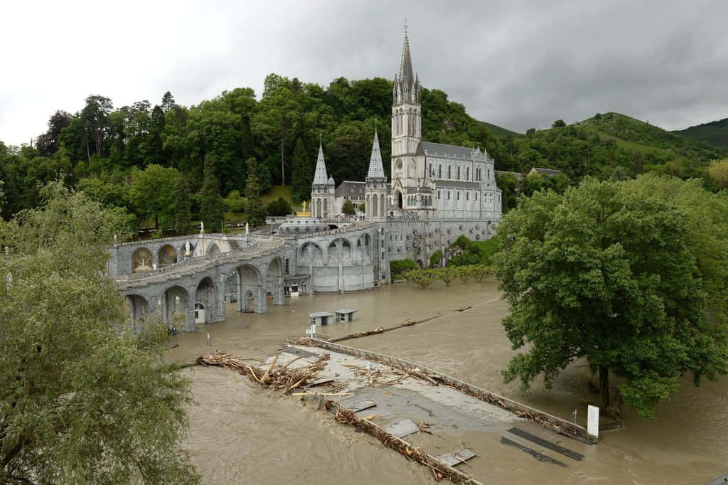Captivating View Of Lourdes Sanctuary In France Wallpaper