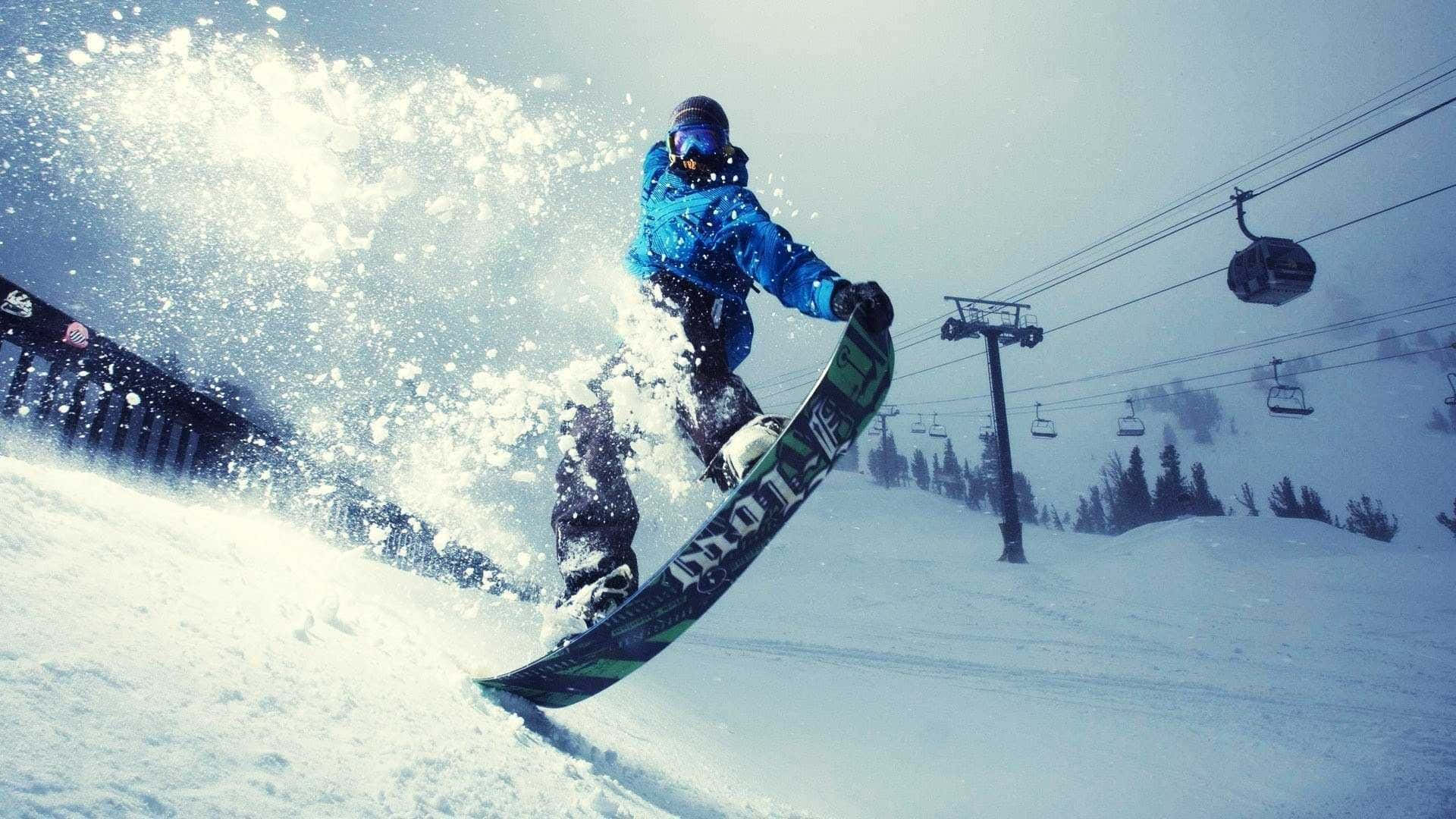 Captivating Winter Wonderland With Snowboarder In Motion Wallpaper