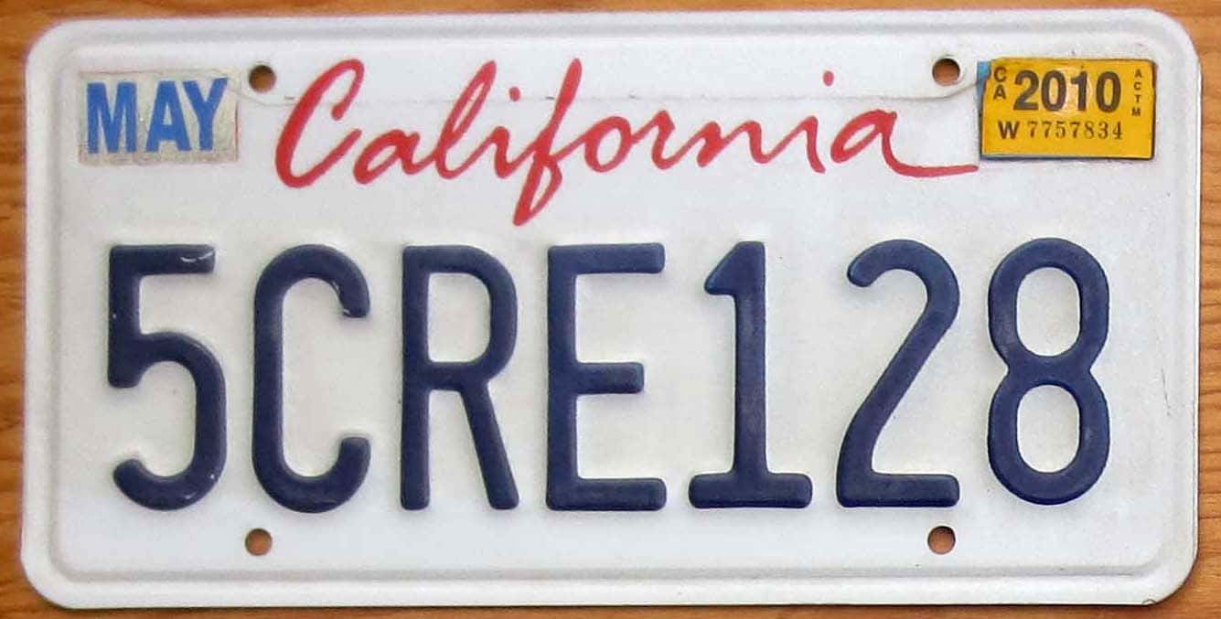 Custom Car License Plate Mounted on Stylish Vehicle Wallpaper