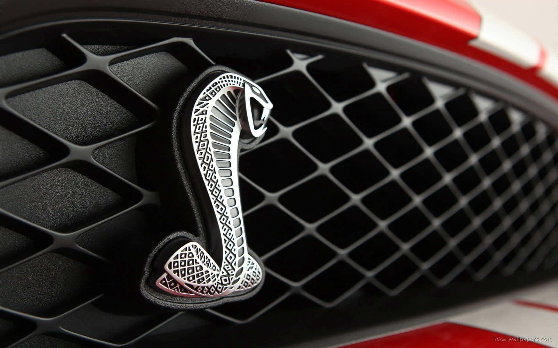 A stunning collection of luxury car logos displayed on a dark background. Wallpaper