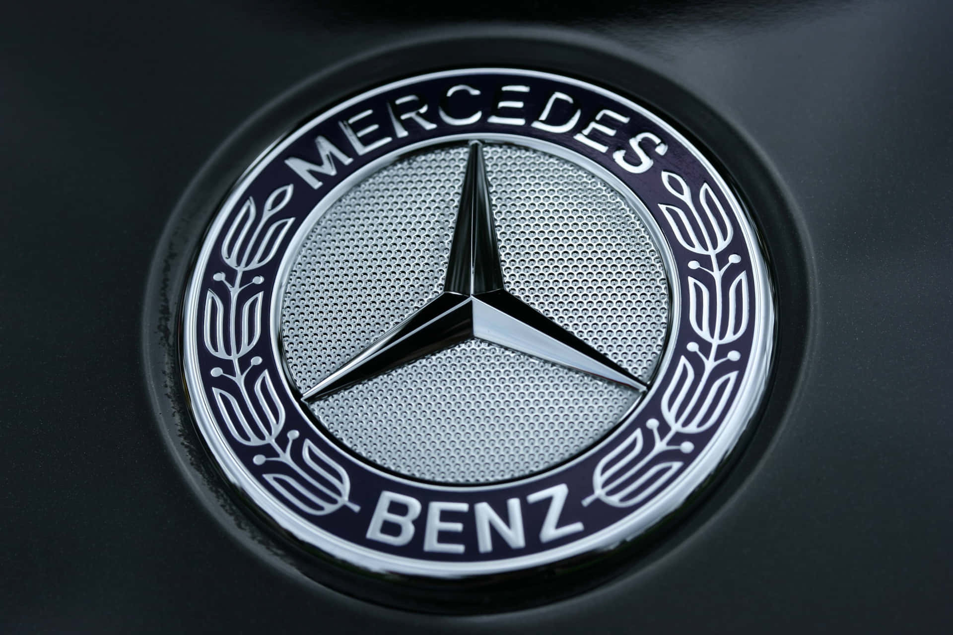 Luxurious Car Logo - Close-up view of a prestigious car emblem Wallpaper