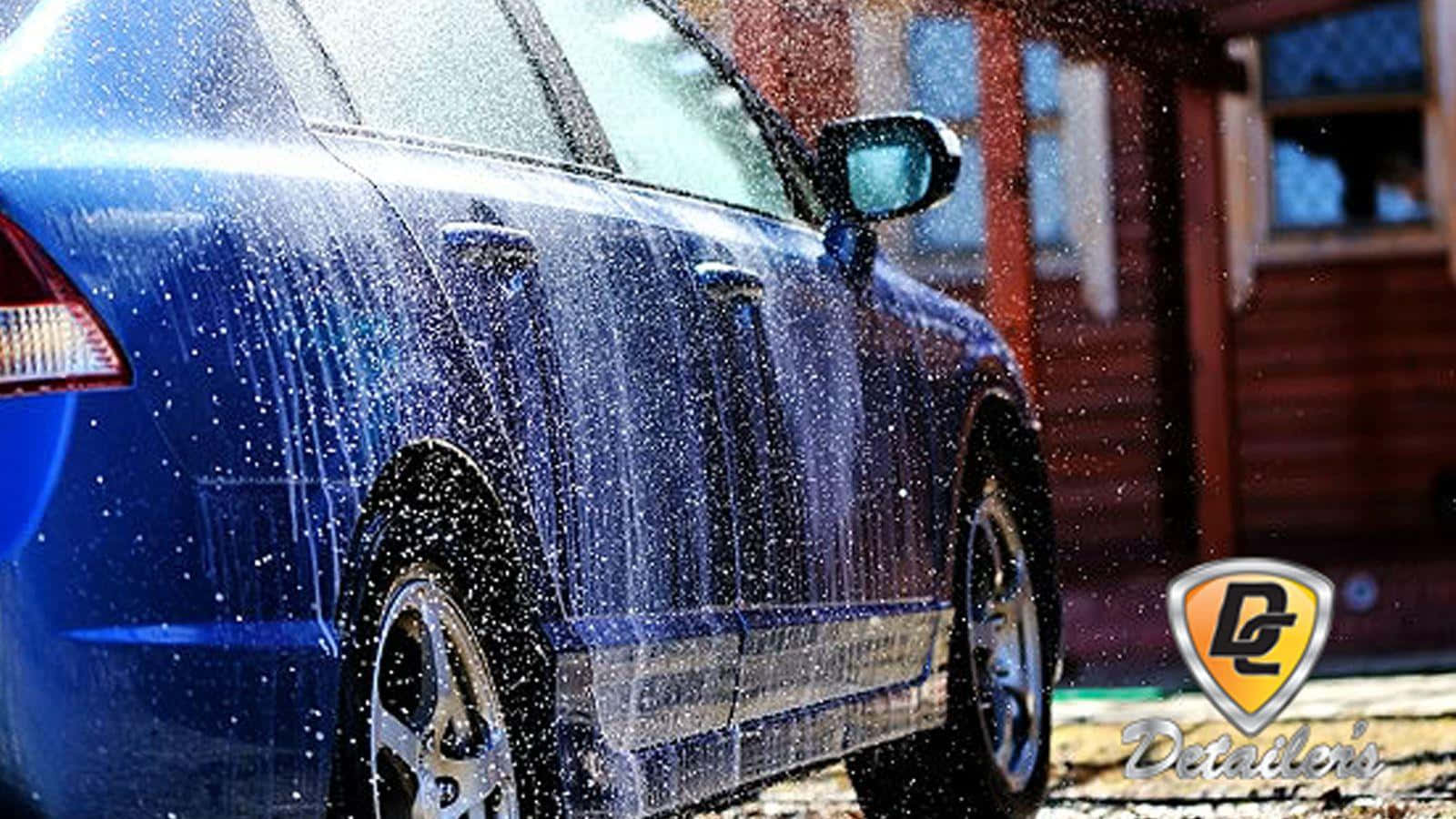 A Blue Car Is Being Washed With Water