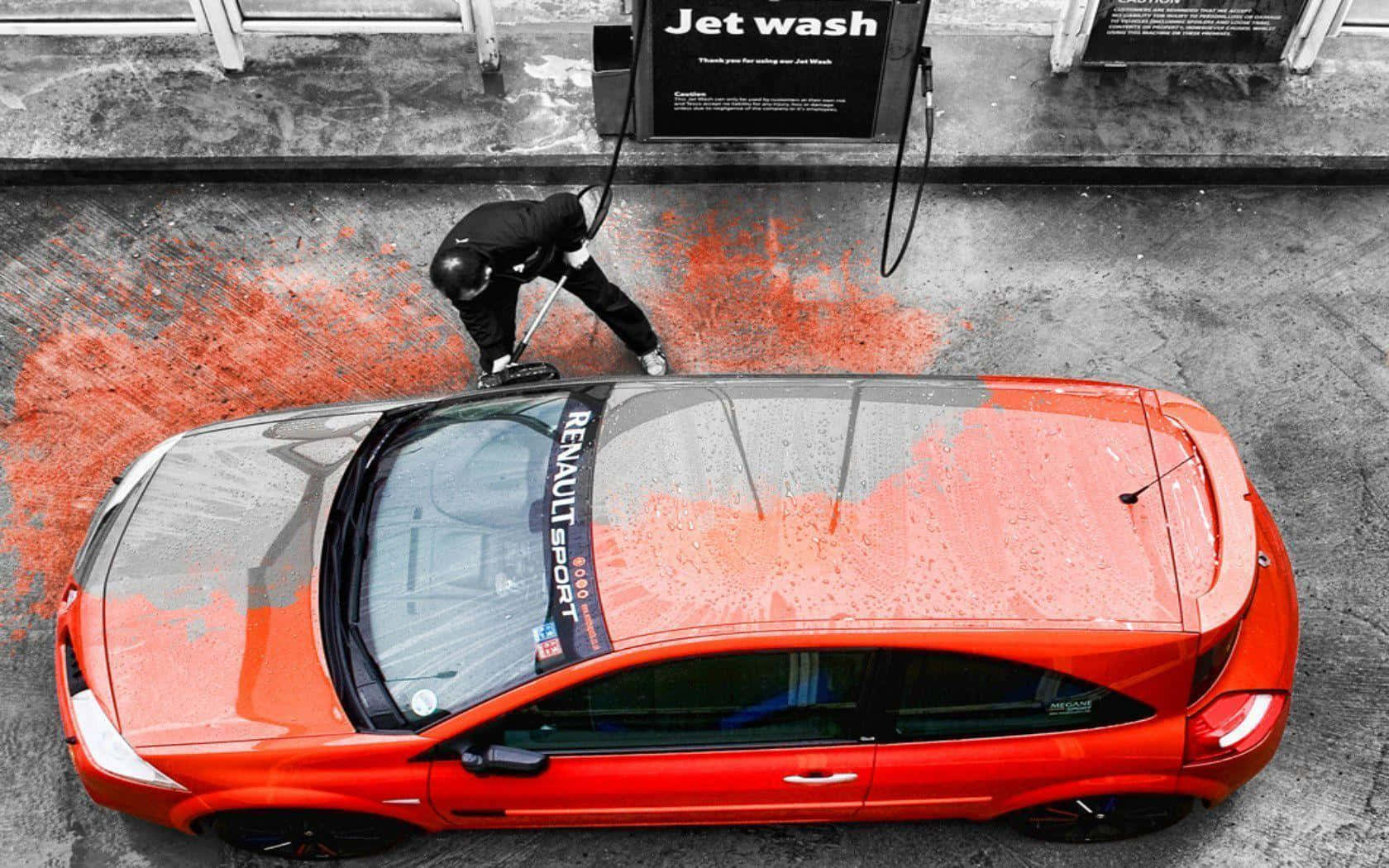 A Man Is Washing A Car With A Jet Wash