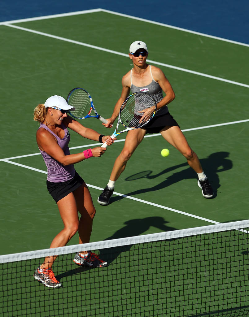 Tennis Stars Cara Black and Anastasia Rodionova in action Wallpaper
