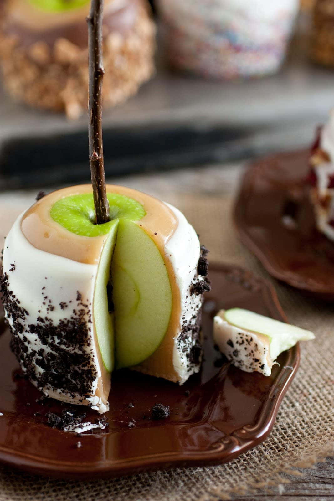 Delicious Caramel Apples with Toppings in a Rustic Set-up Wallpaper