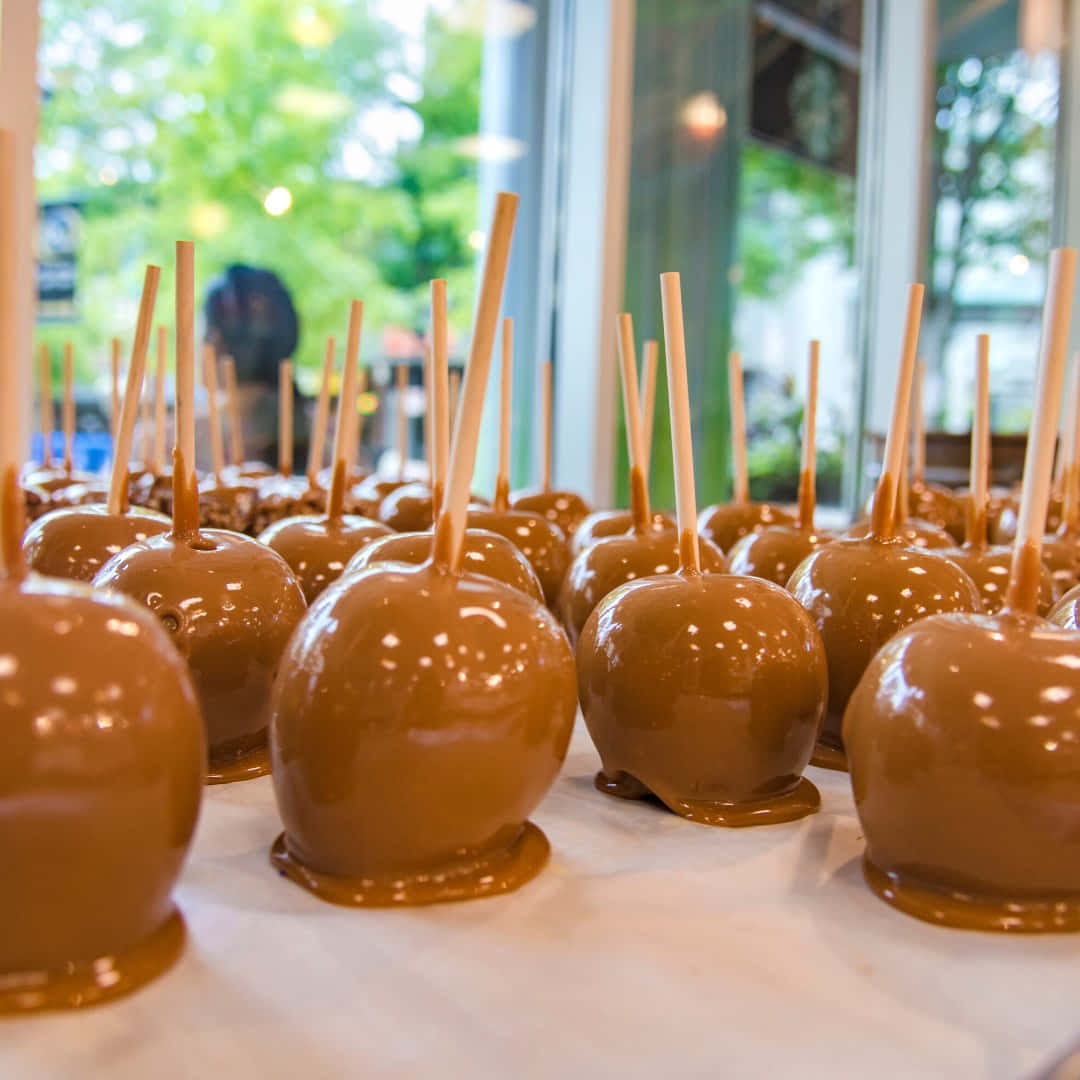 Delicious Caramel Apples with a Variety of Toppings Wallpaper