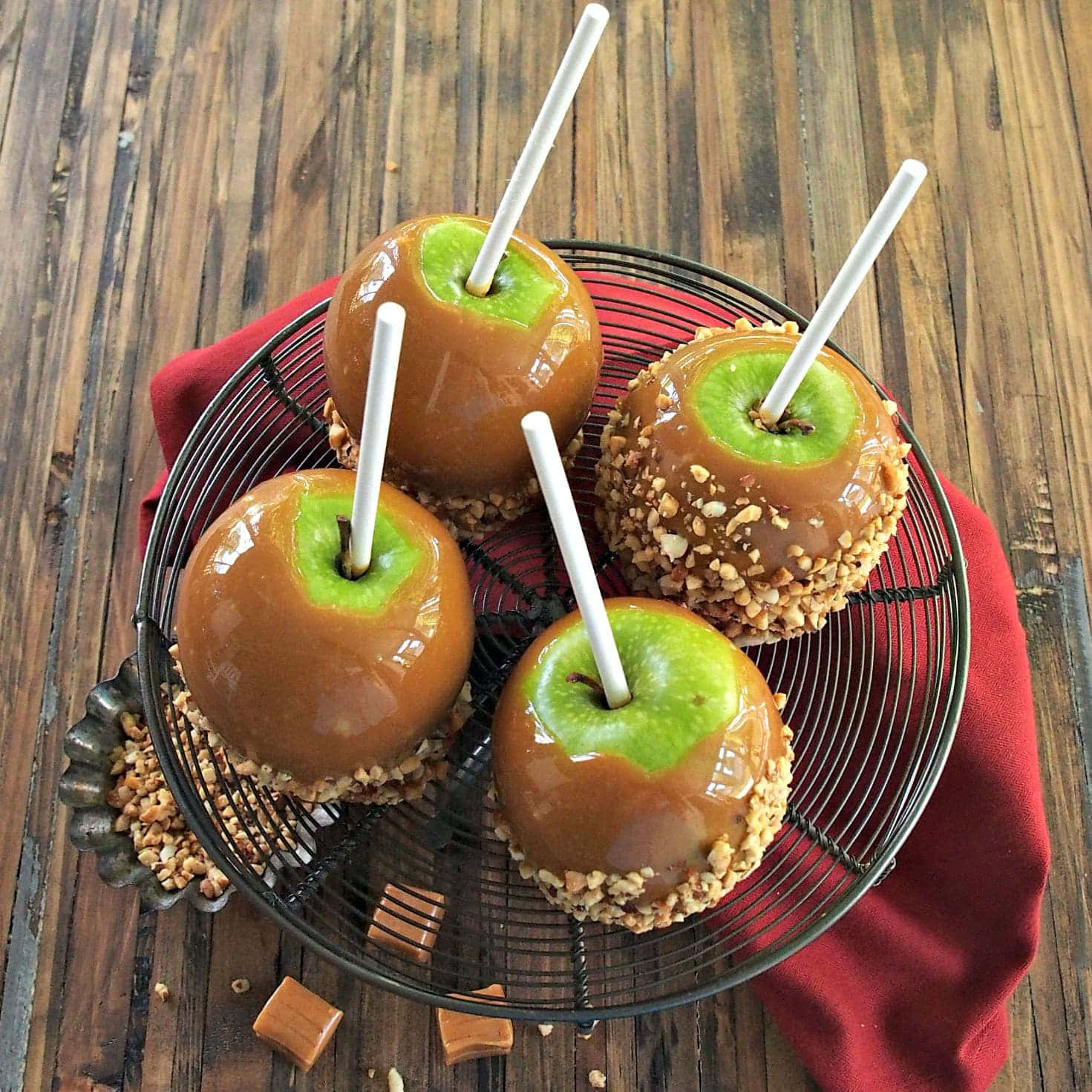 Delicious Caramel Apples on a Rustic Wooden Table Wallpaper
