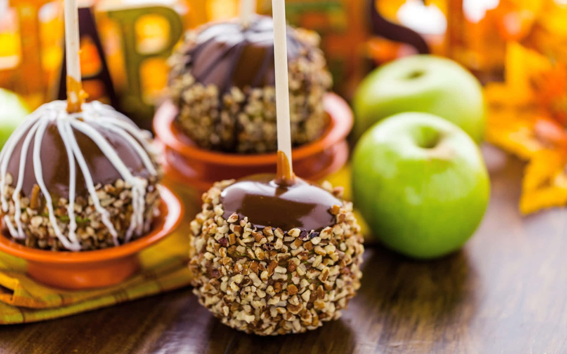 Mouthwatering Caramel Apples on Rustic Wood Table Wallpaper