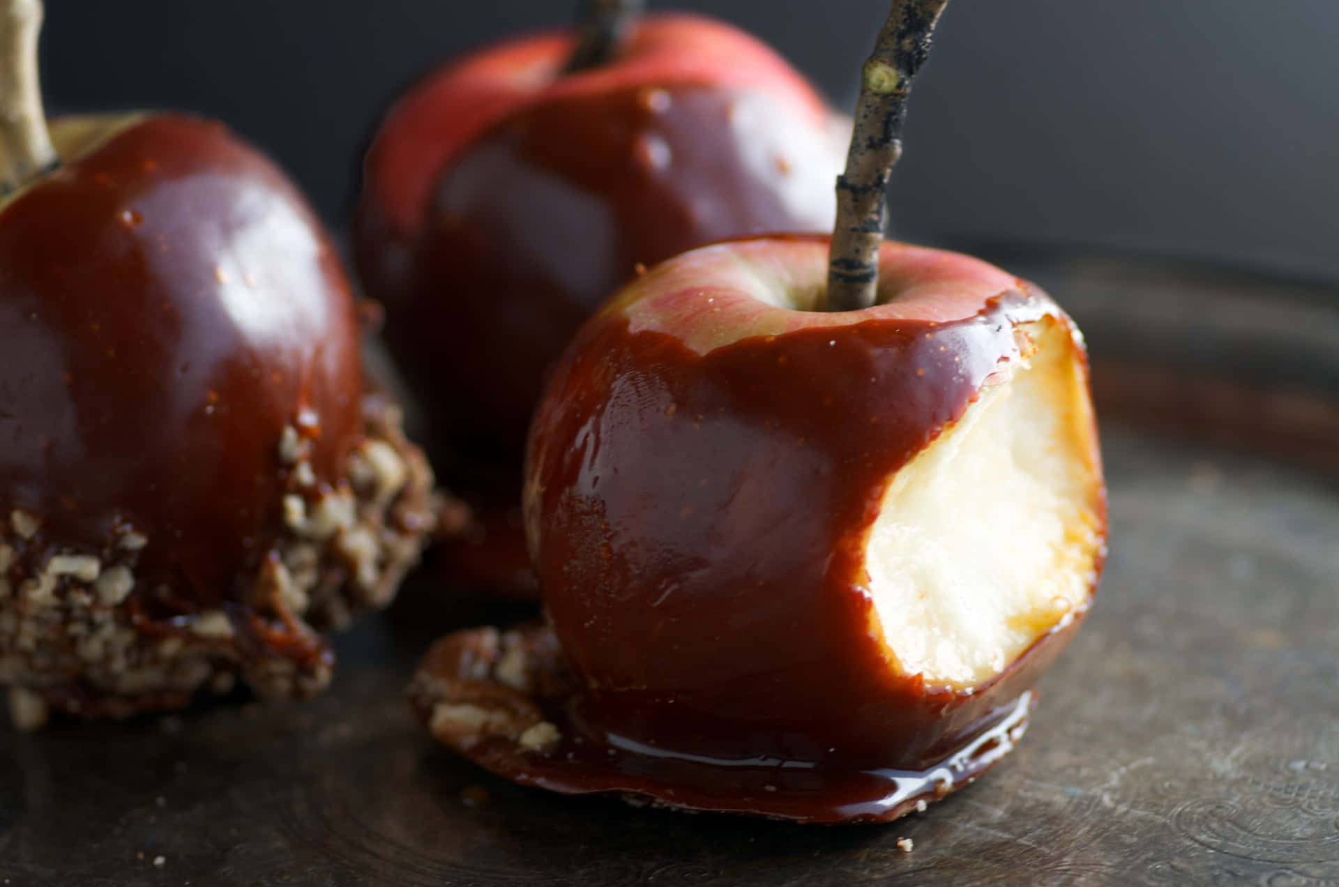 Delectable Caramel Apples on a Rustic Table Wallpaper