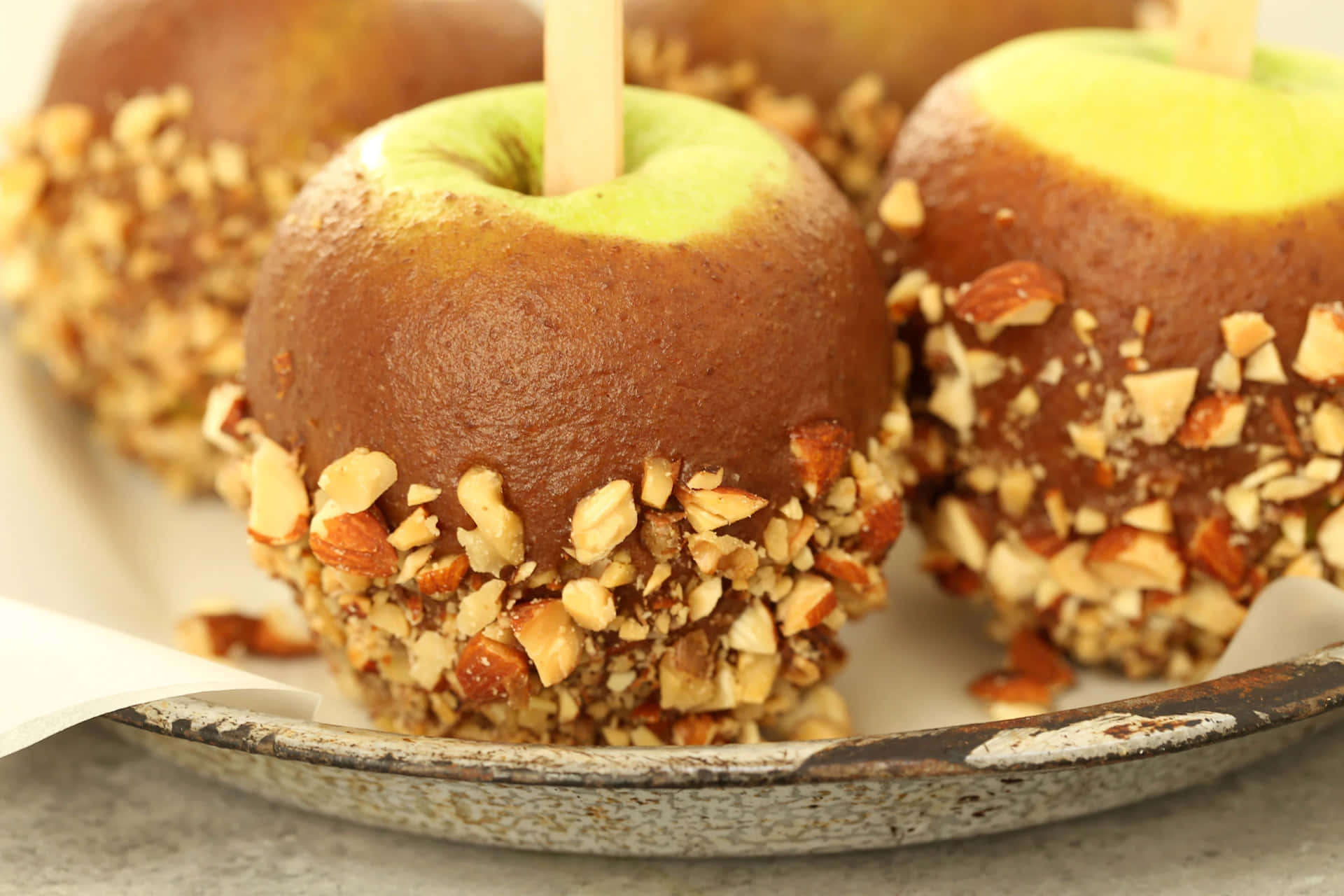 Delicious caramel apples with a variety of toppings Wallpaper