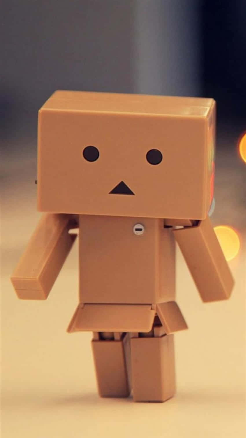 A Brown Toy Robot Is Standing On A Table