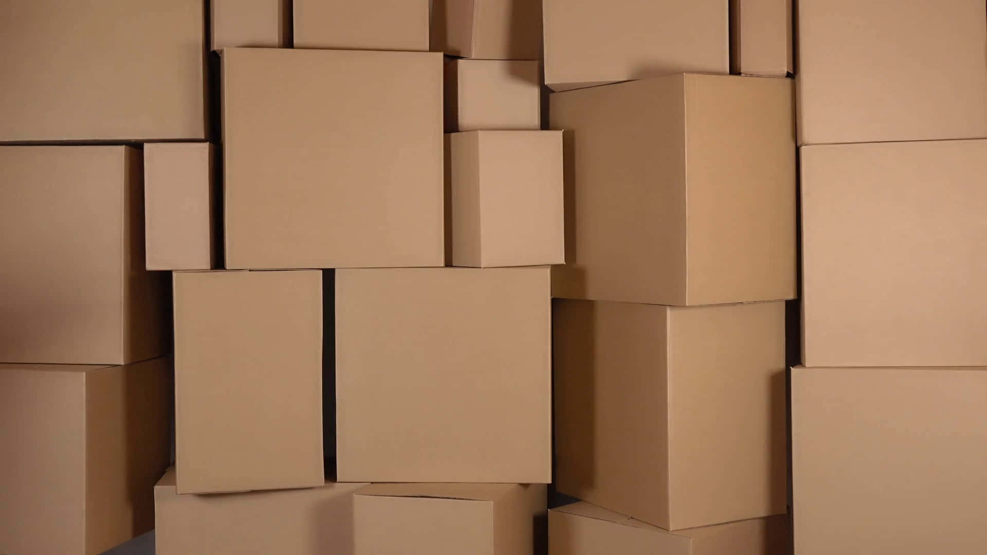 A Bunch Of Cardboard Boxes Stacked Up Against Each Other