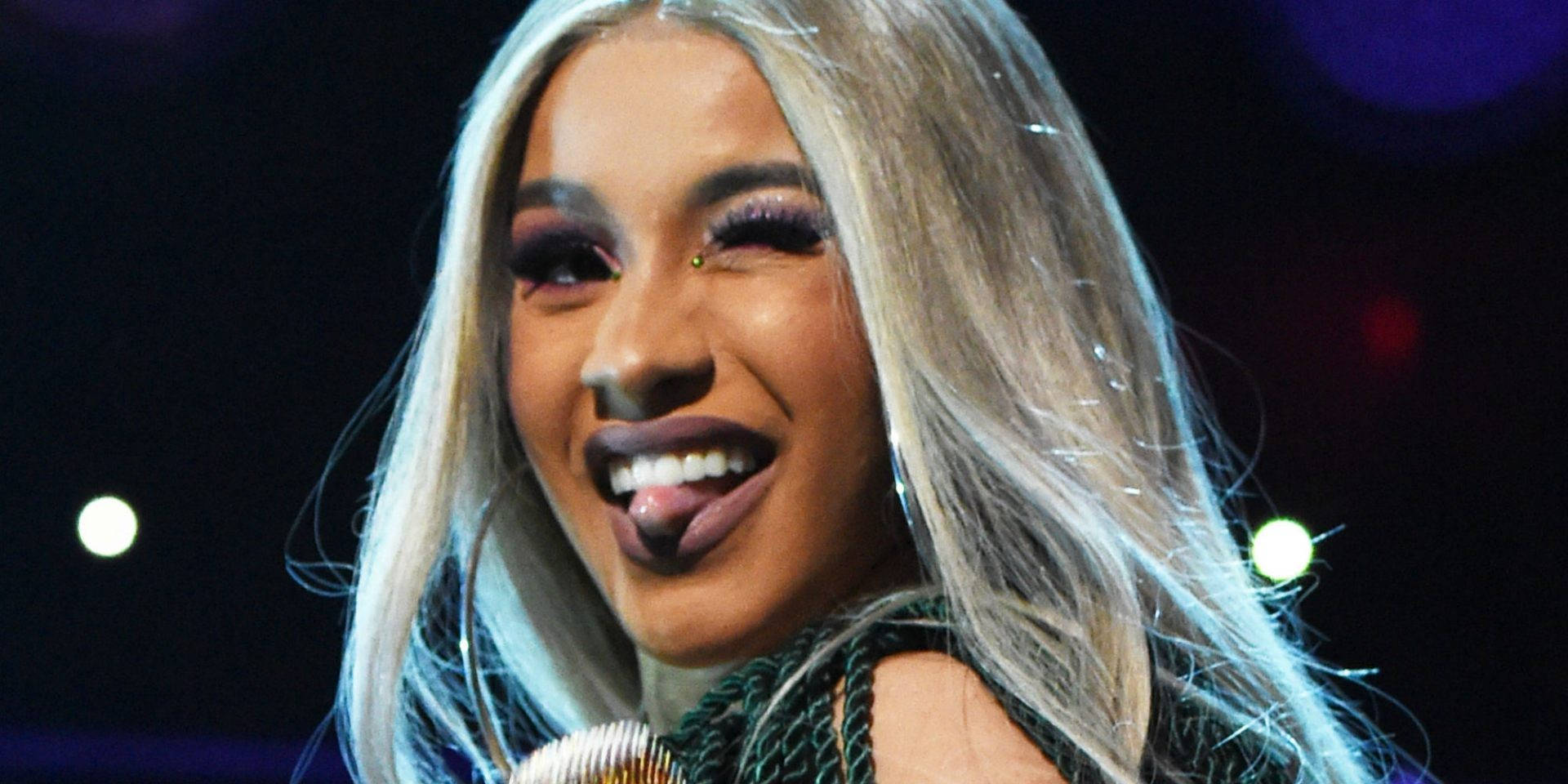 Cardi B Winking With Tongue Out Background