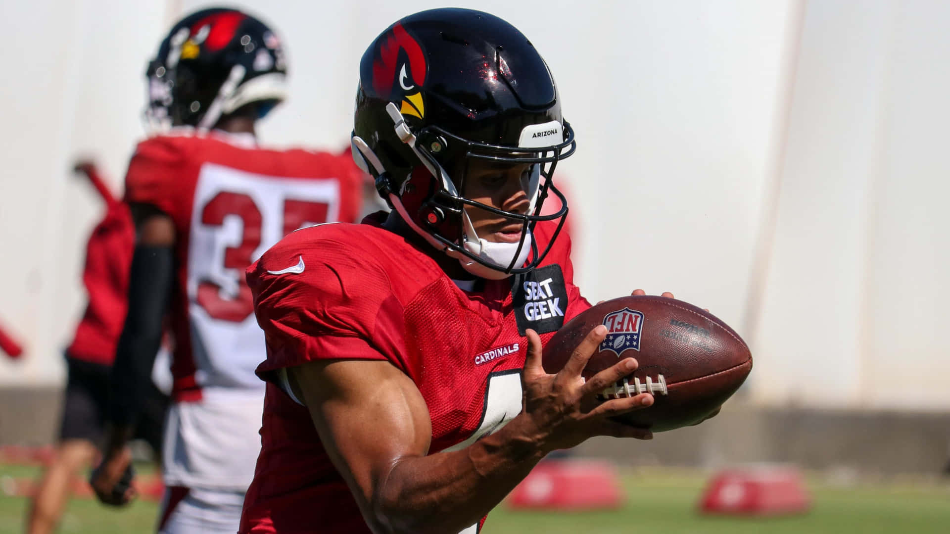 Cardinals Player Catching Football Practice Wallpaper