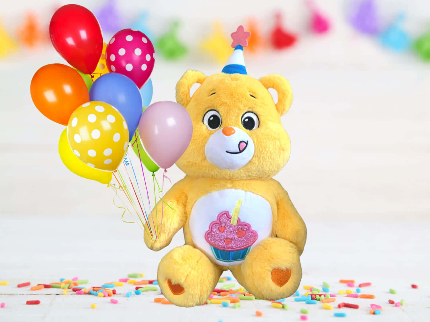 A smiley Care Bear surrounded by friends.