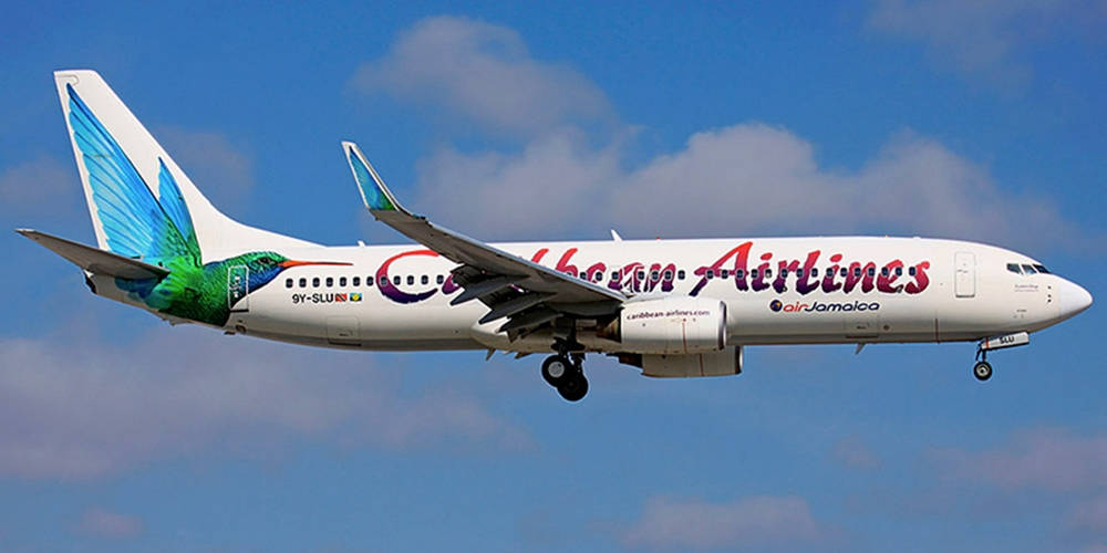 Caribbean Airlines Flying In The Blue Sky Wallpaper