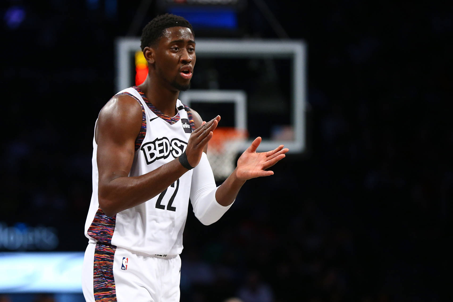 Caris LeVert energetically clapping on the basketball court Wallpaper