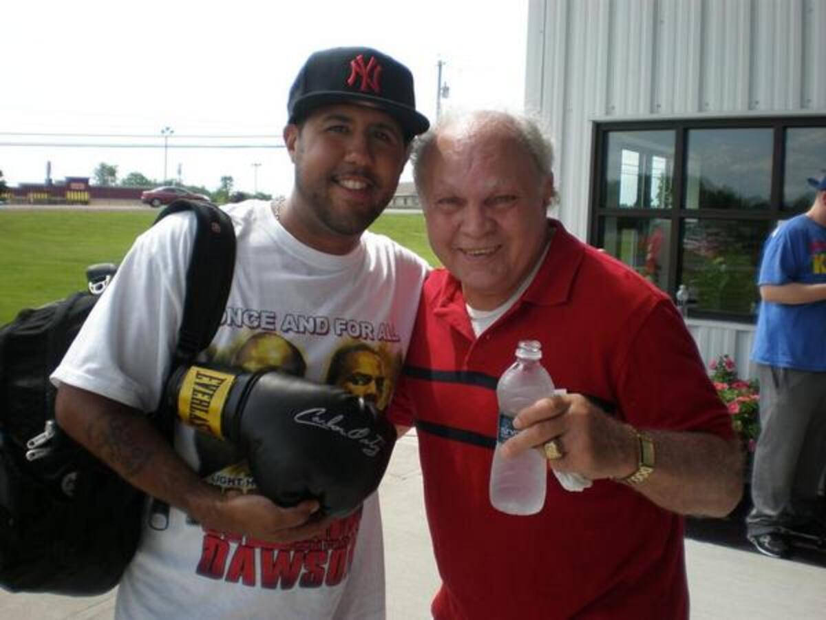 Carlos Ortiz Next To Fan With Boxing Glove Wallpaper