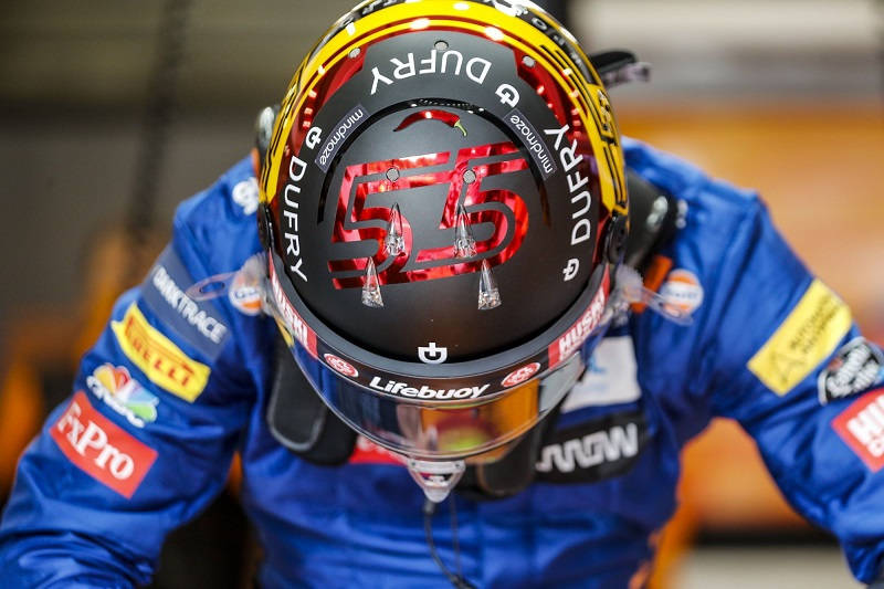 Carlos Sainz Jr., A Racehorse Running Through The Circuit In His Racing Gear. Wallpaper