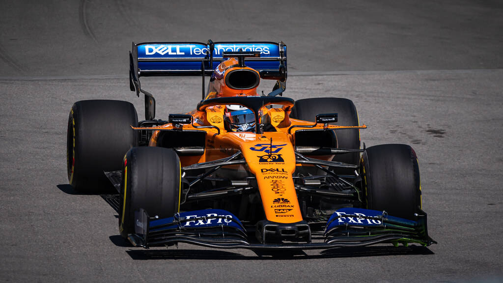 Carlos Sainz Jr Piloting McLaren F1 Race Car Wallpaper