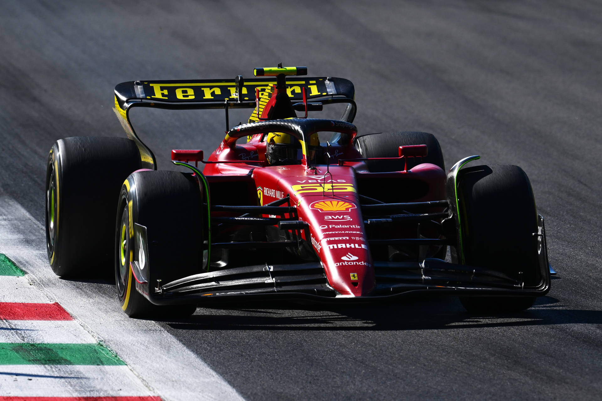 Carlos Sainz Jr in his blazing red Ferrari at a Grand Prix Wallpaper