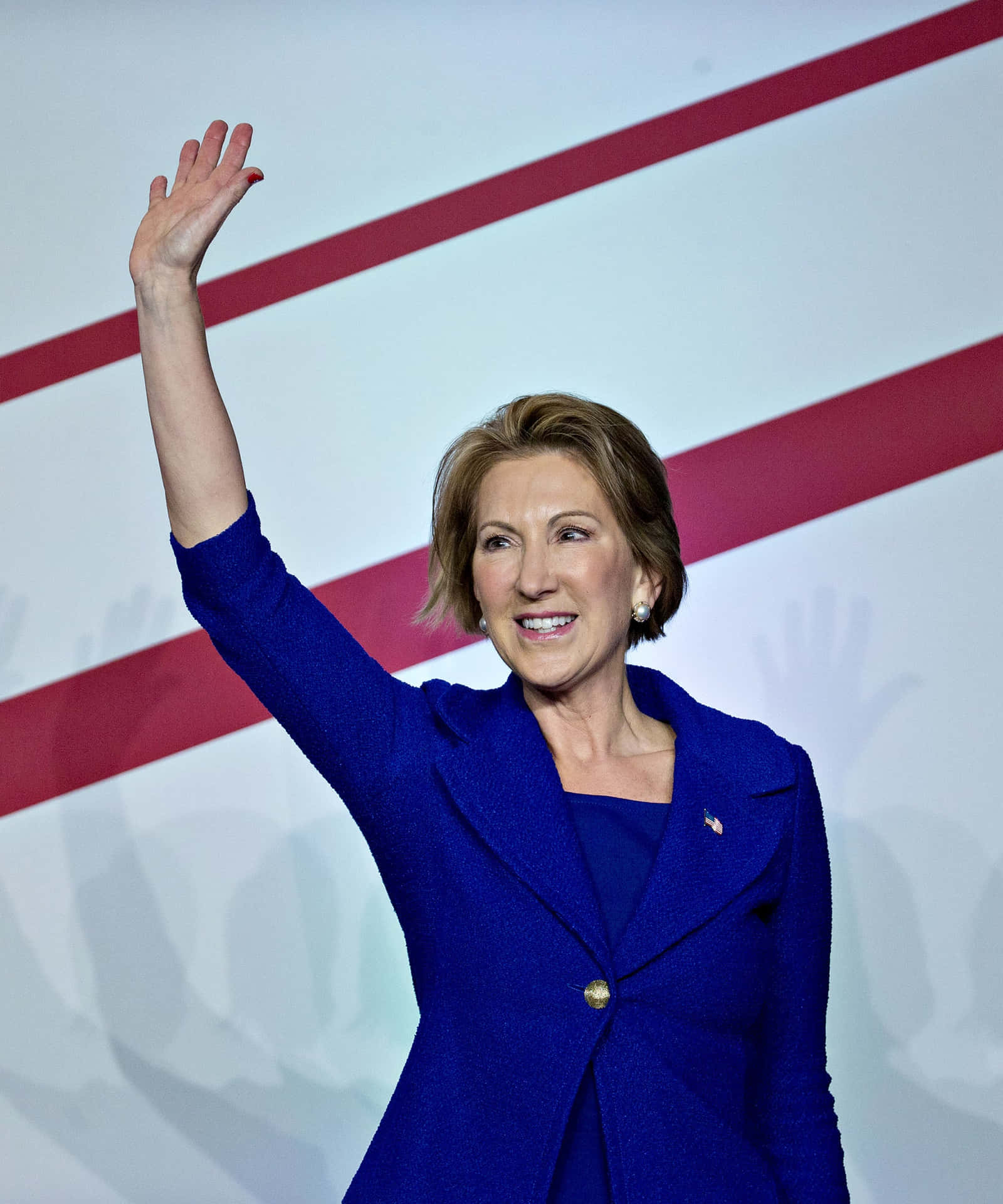 Carly Fiorina Waving While On Stage Wallpaper