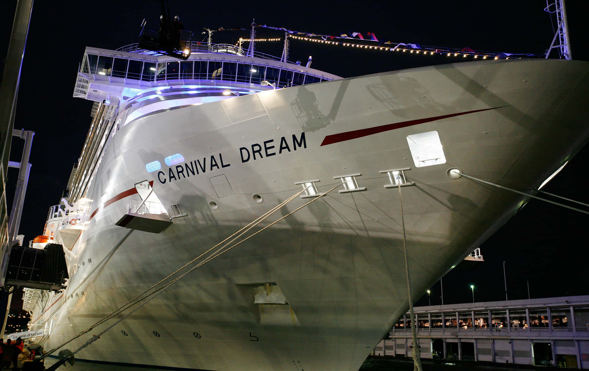 A Large Cruise Ship Docked At Night