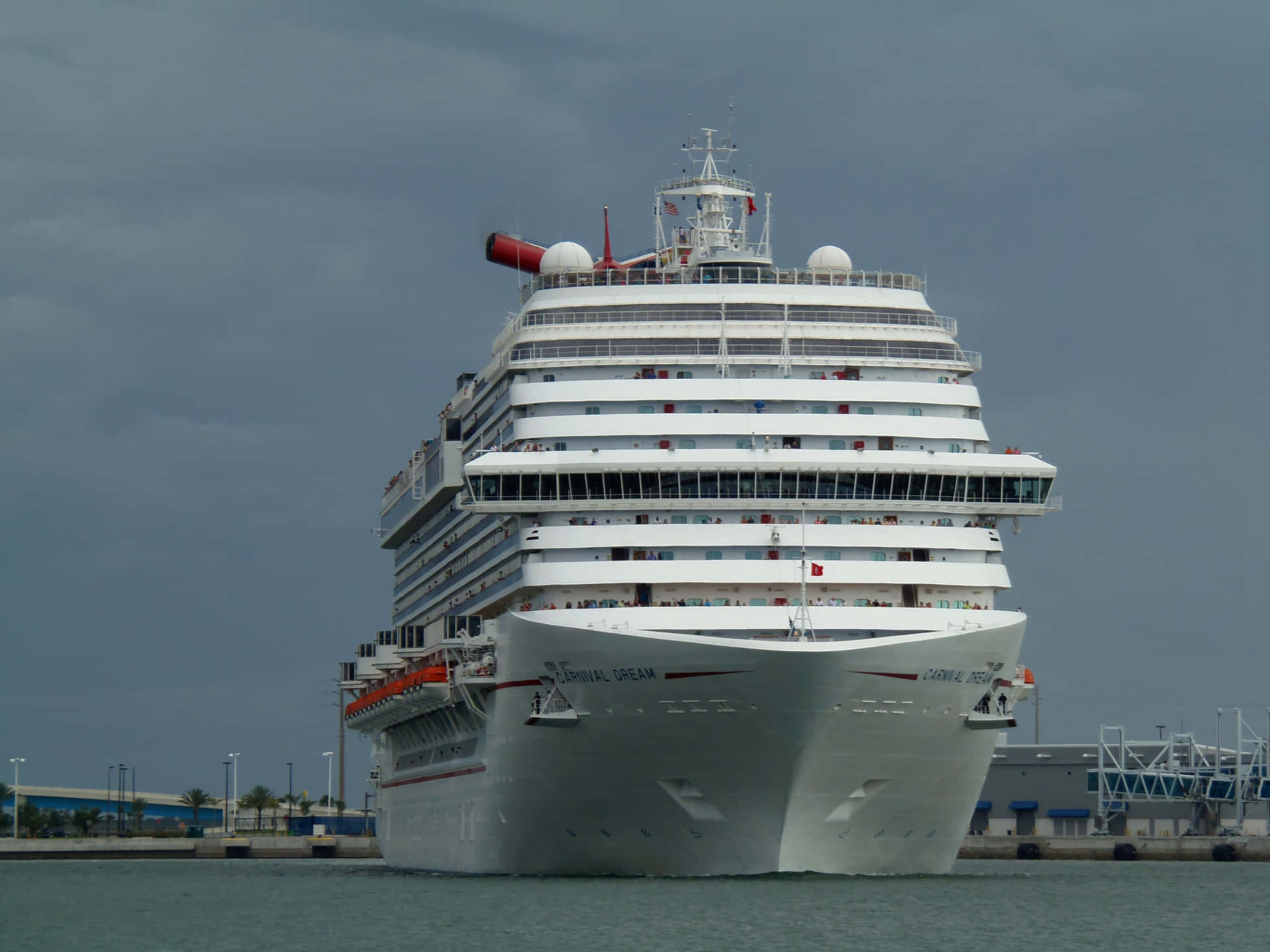 A Large Cruise Ship Is Docked In A Harbor