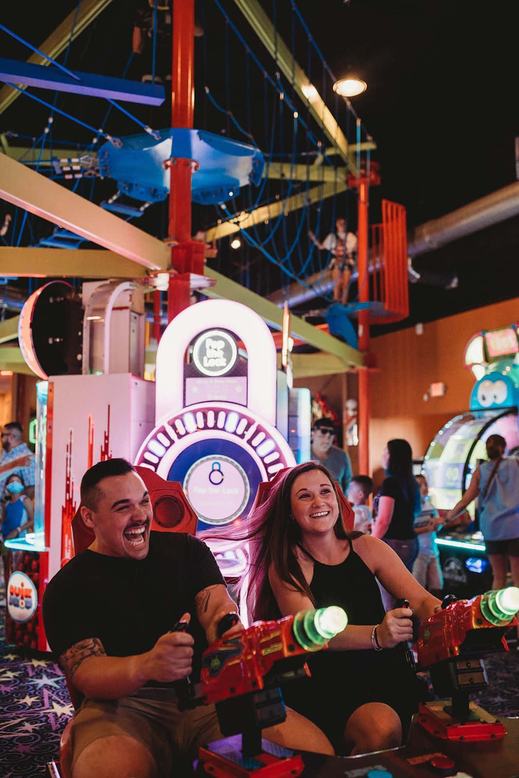 Couple Playing Arcade At Carnival Picture