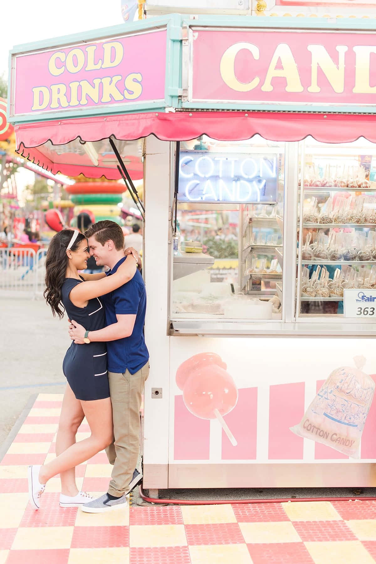 Couple Kissing In Front Of Carnival Cart Picture