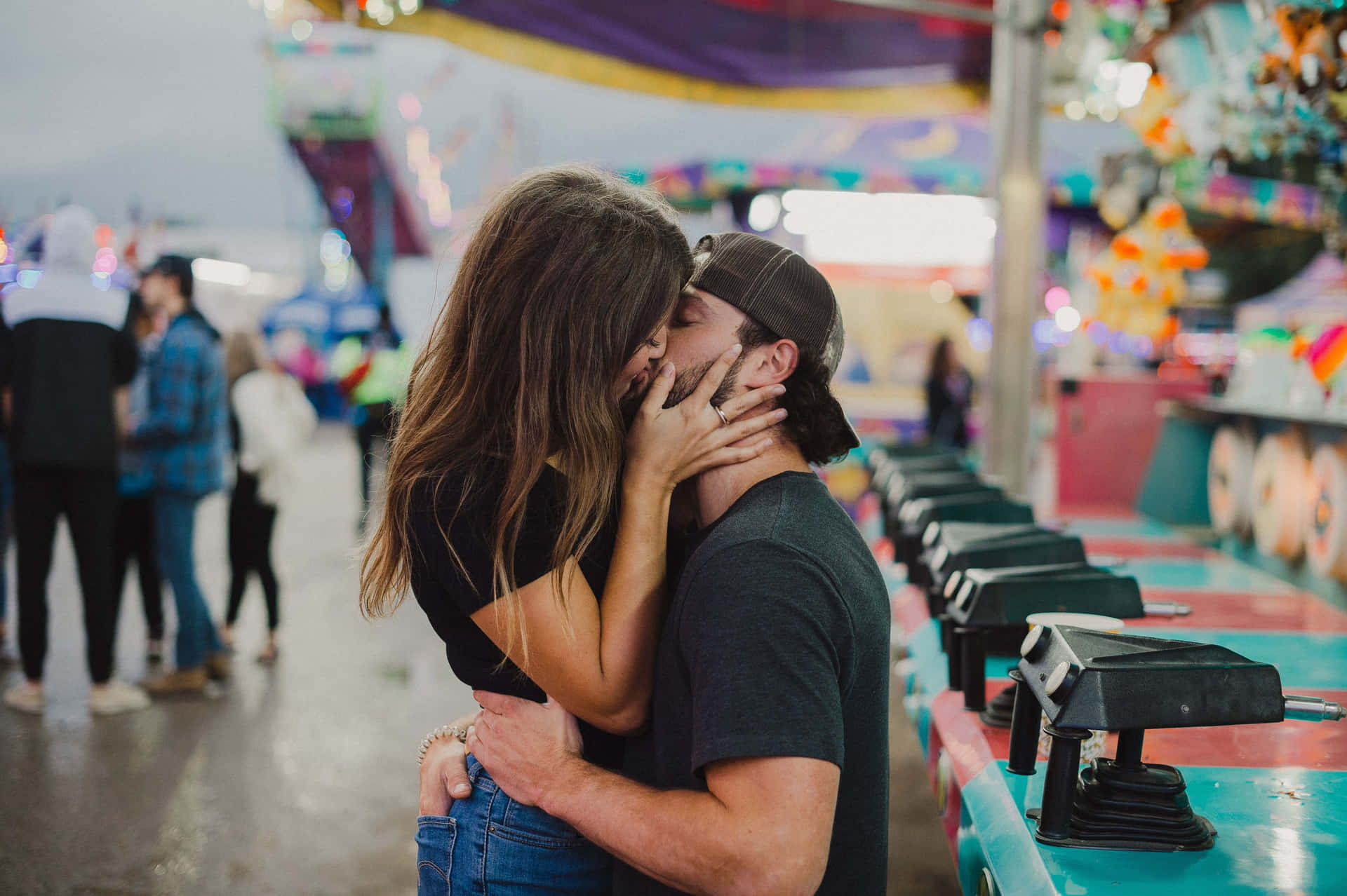 Kissing Couple In Front Of Carnival Ride Picture