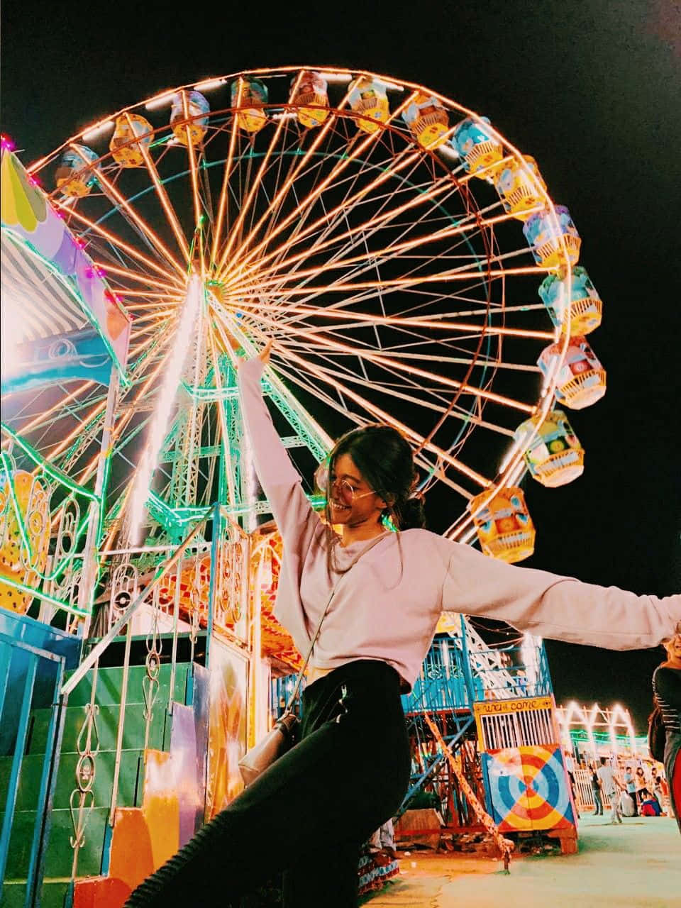 Dancing Woman In Front Of Carnival Wheel Picture
