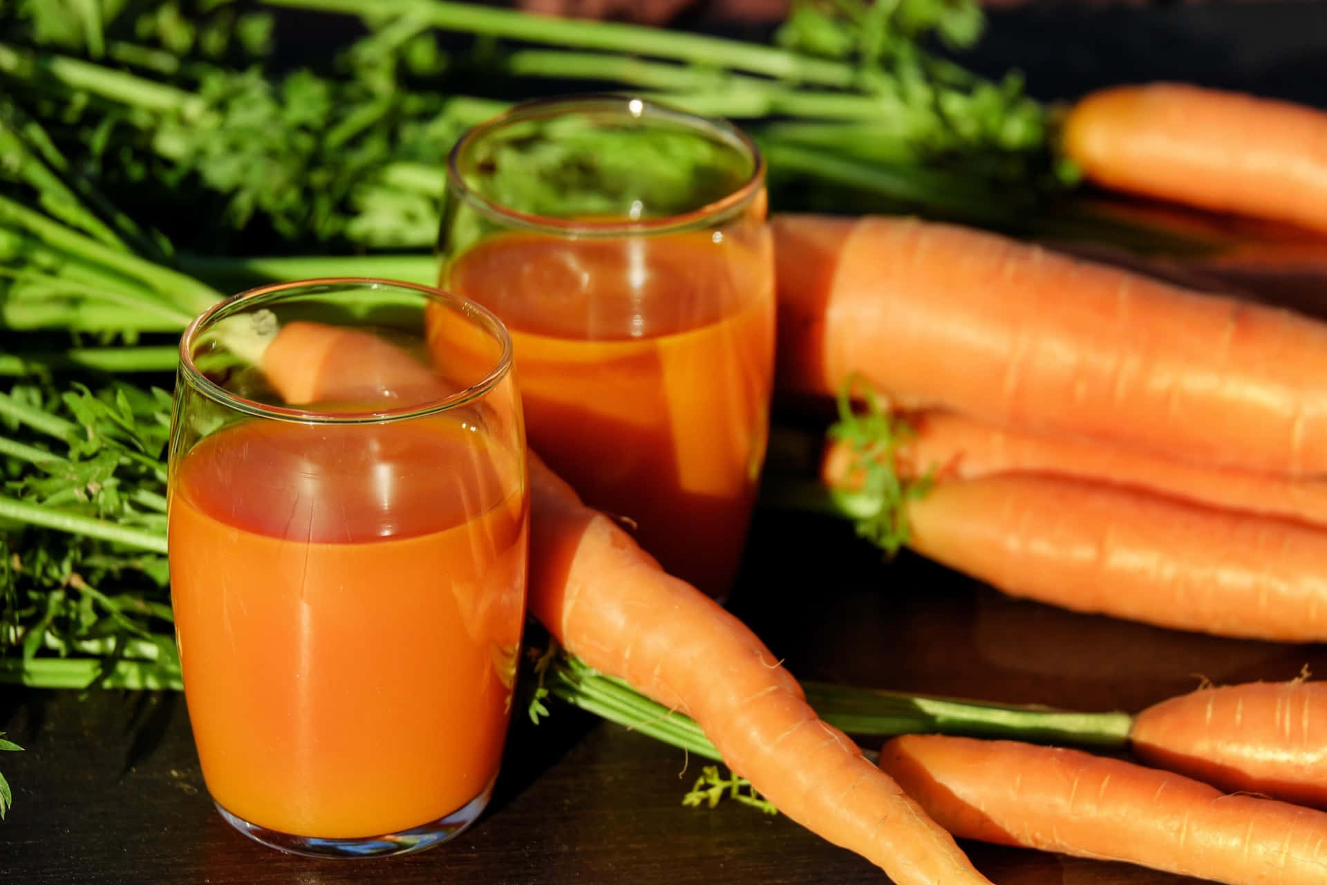 Carrot Juice And Glasses Of Water On A Table