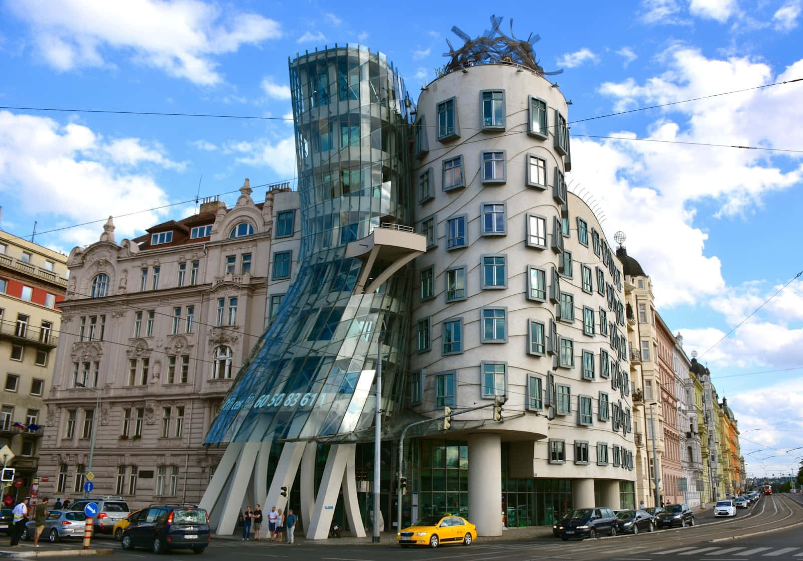 Cars Passing By Dancing House Wallpaper