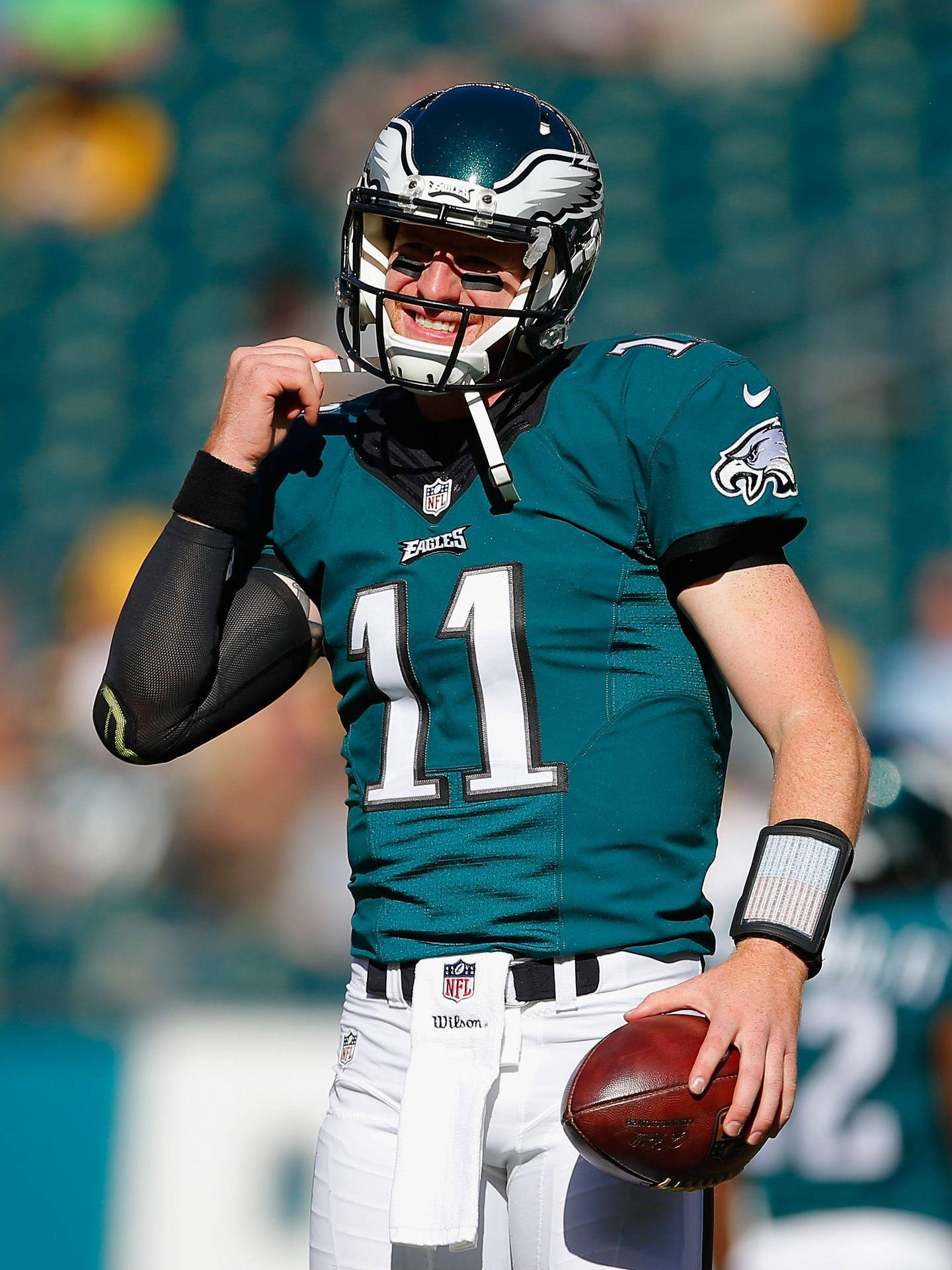 (in The Context Of Computer Or Mobile Wallpaper, This Could Be The Caption For An Image Of Philadelphia Eagles Quarterback Carson Wentz In His Green Uniform, Suitable For Use As A Background Image On A Device.) Wallpaper