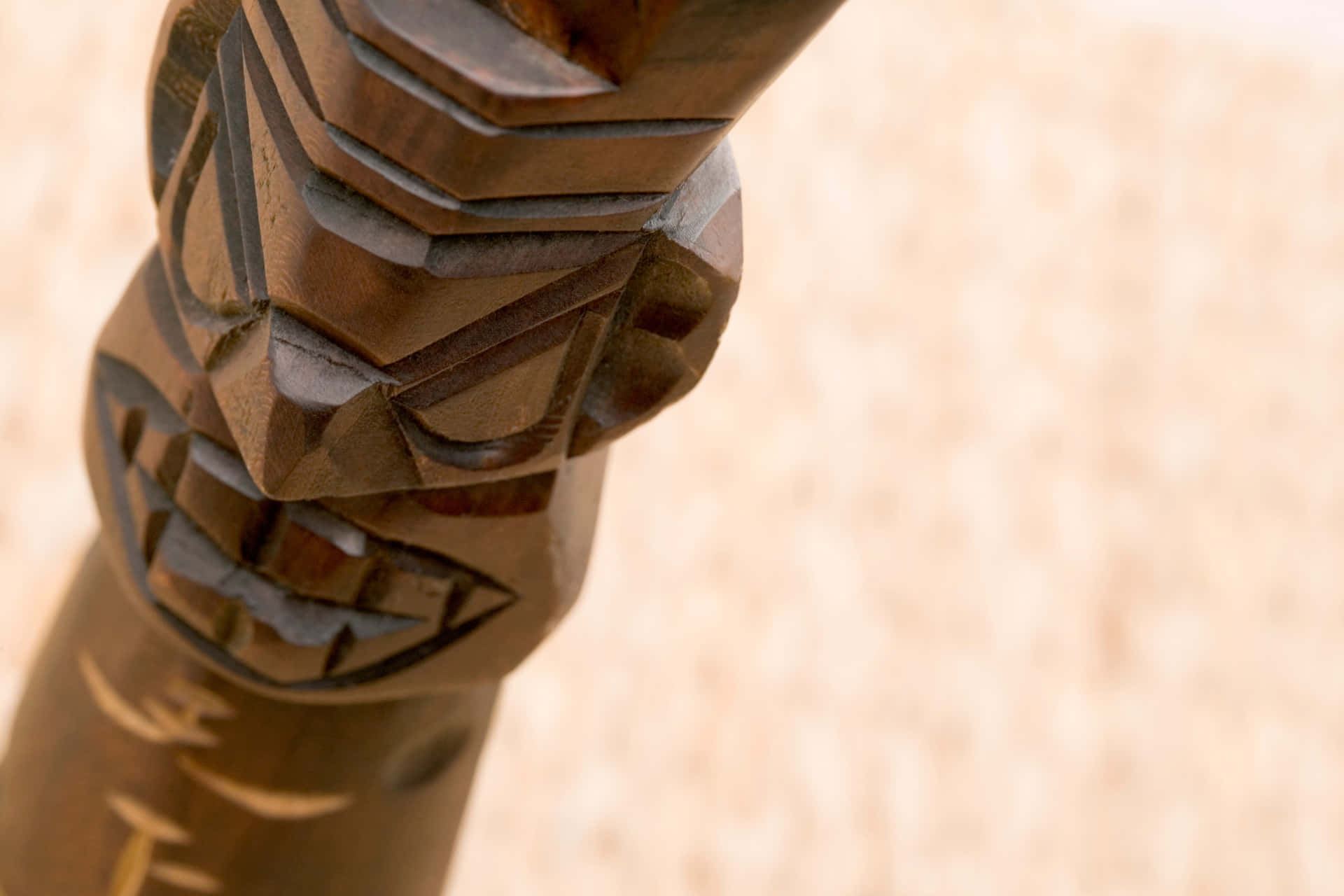 Carved Wooden Tiki Statue Sand Background.jpg Wallpaper