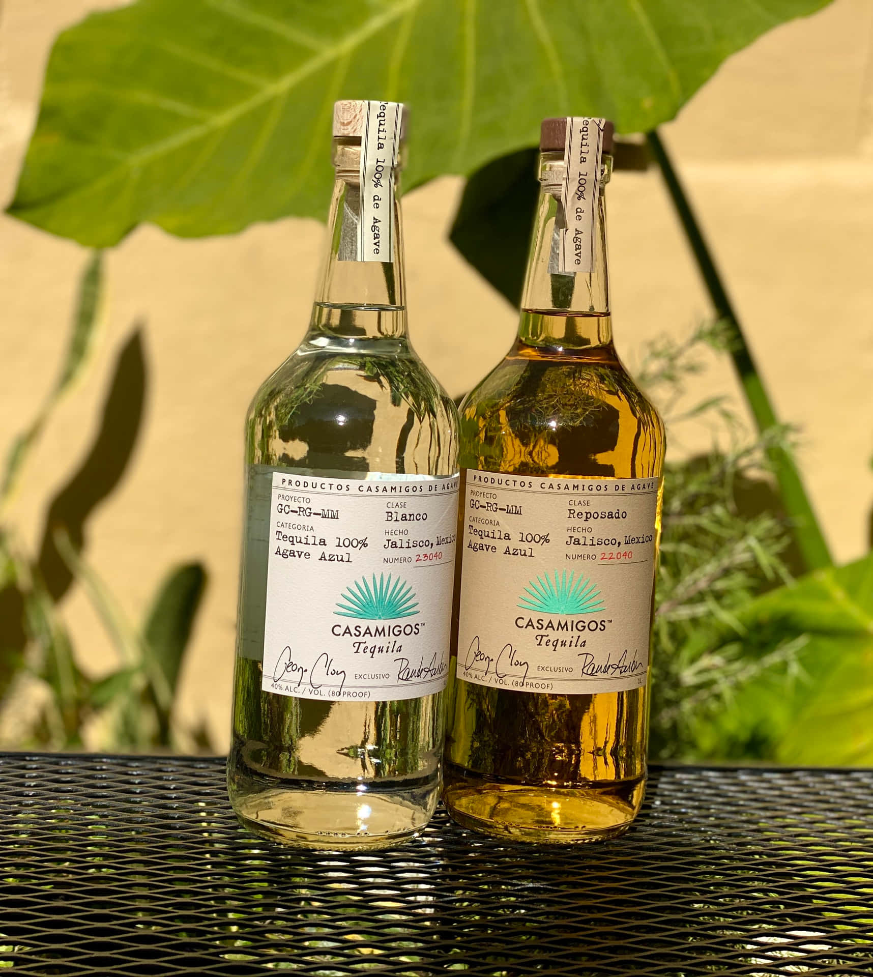 Casamigos Tequila Blanco And Reposado Liquor Bottles On Mesh Table Picture