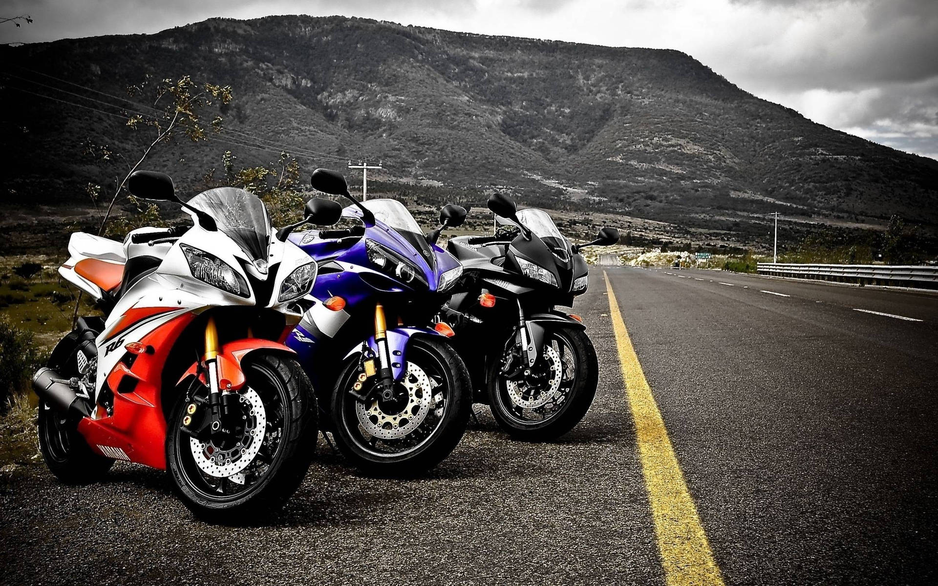Cascading Motor Bikes And Mountain View Background