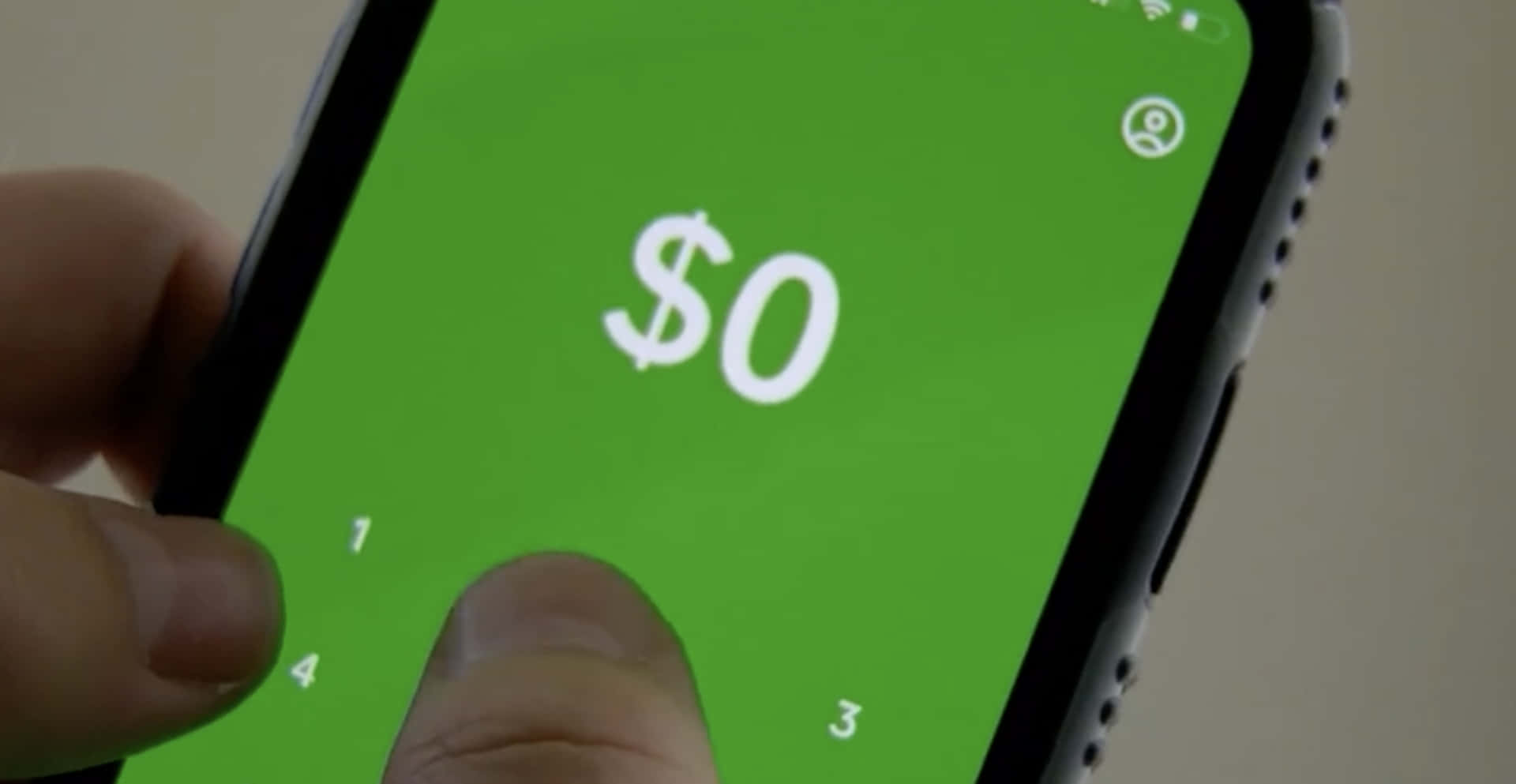 A Person Is Holding A Green Phone With A Dollar Sign On It