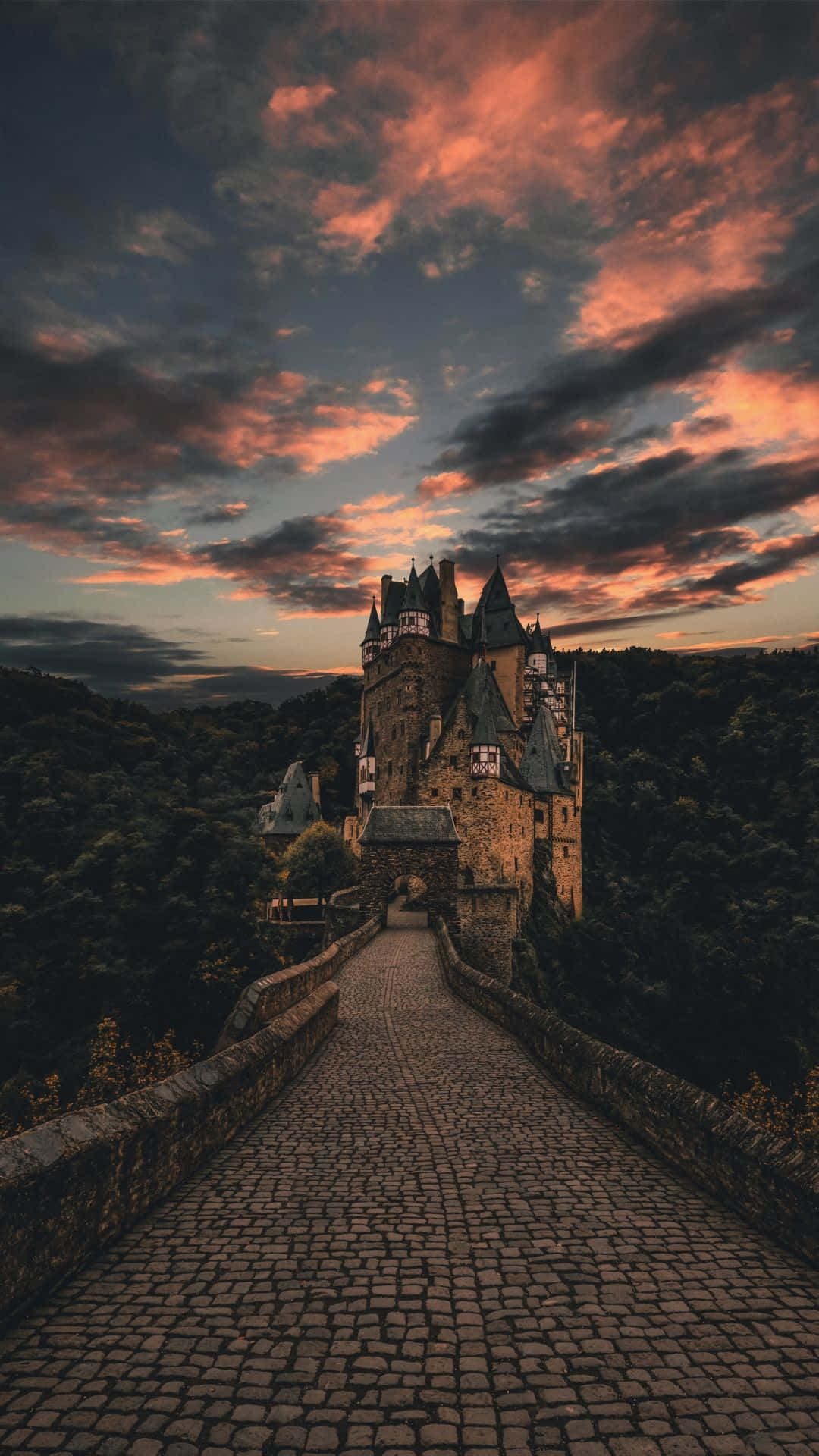 A breathtaking view of a castle in the middle of a grand landscape Wallpaper