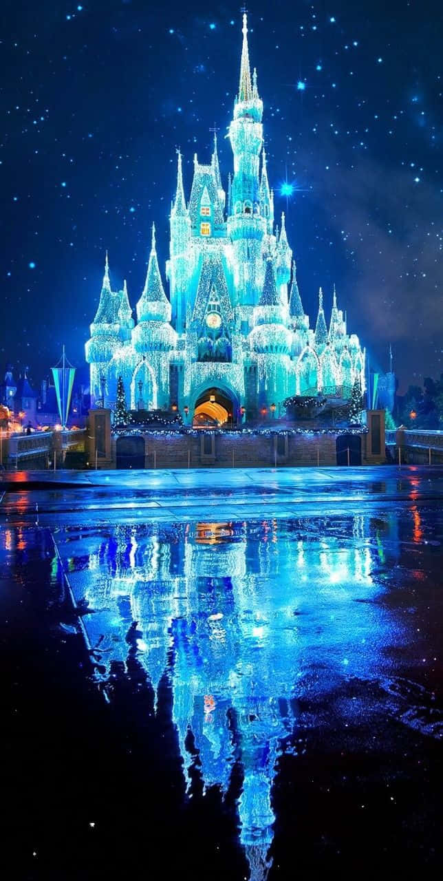 A Castle Is Lit Up With Blue Lights At Night Wallpaper