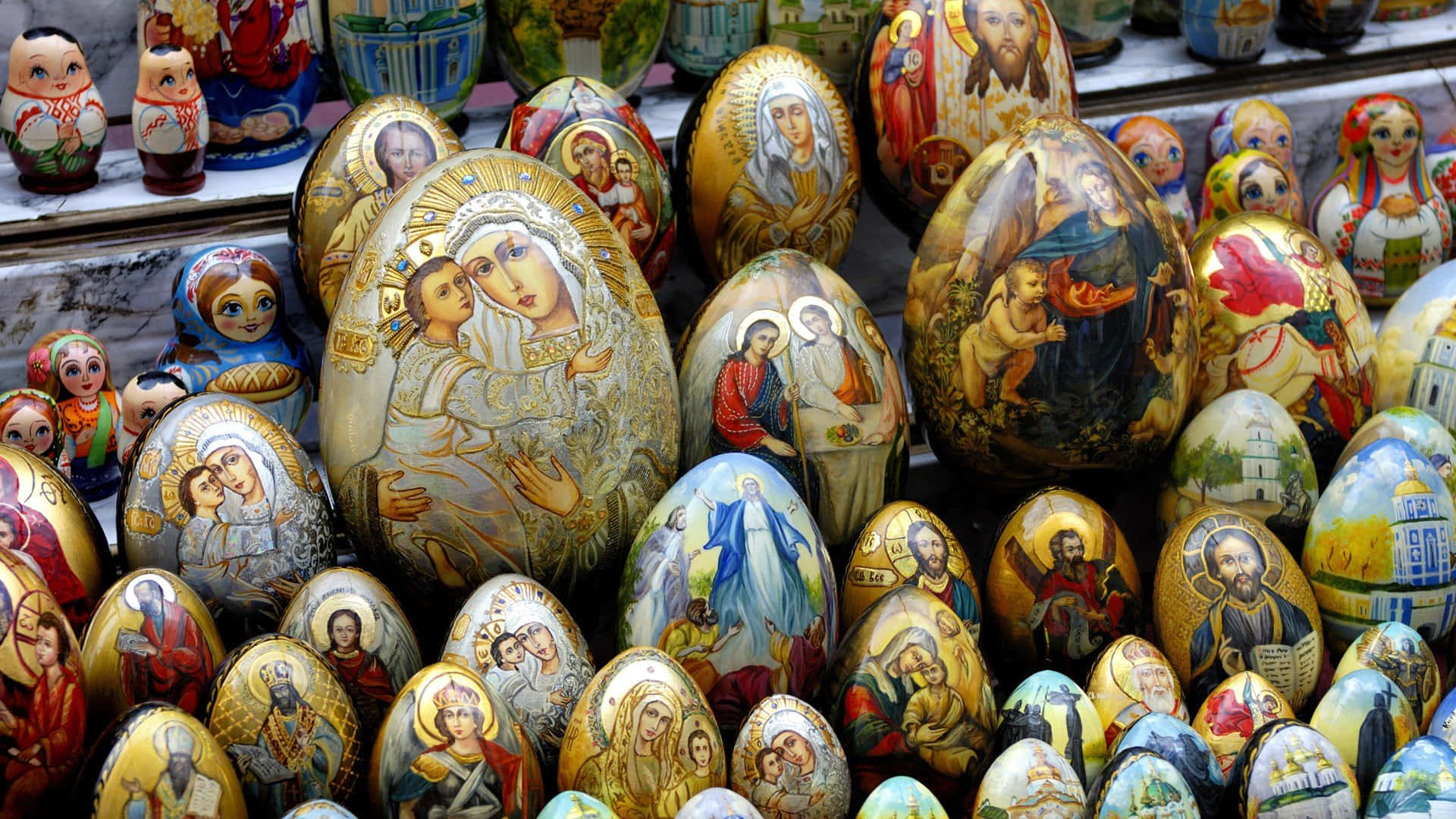 A Display Of Painted Eggs With Religious Images Wallpaper
